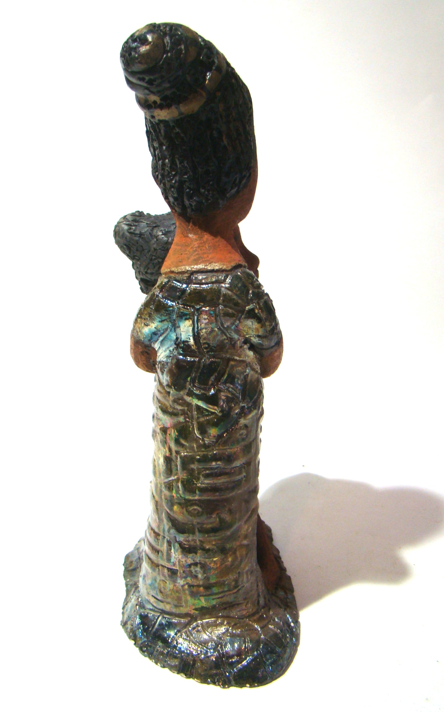 Girl Talk with my Mom stands 13' x 7" x 4" and weighs 14.lbs. They were raku fired etched metallic copper dresses. Their hair is made of clay and raised into an etched bun. They have lovely honey brown complexions and long loving arms. Girl Talk with my Mom would remind one of those special moments in tim
