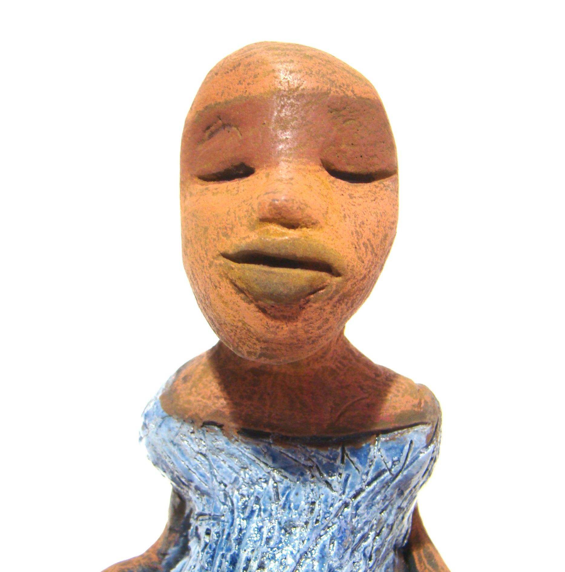Vida sits 5" x 6" x 3" and weighs 10 ozs.     She is in a comfortable yoga pose.     Vida has a lovely honey brown complexion without hair.     Vida has a textured light blue with matching blue shoes.