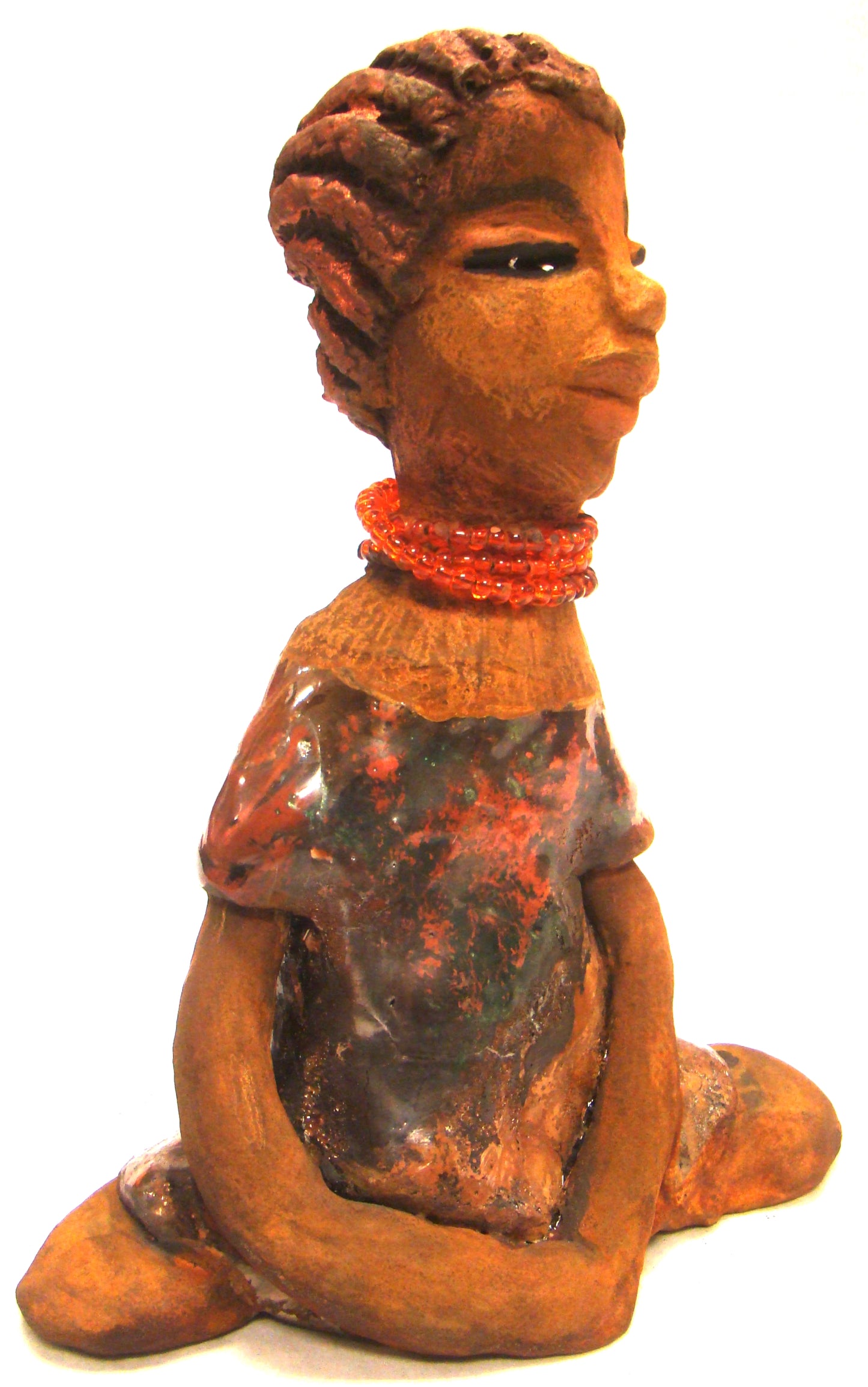 Meet Devonte! Devonte stands 8" x 6" x 4" and weighs 1.06 lbs. Devonte has a awesome honey brown complexion. She has braided clay hair. Devonte has long loving arms. She wears a metallic copper dress with red orange beads. Give Devonte a special place in your home!