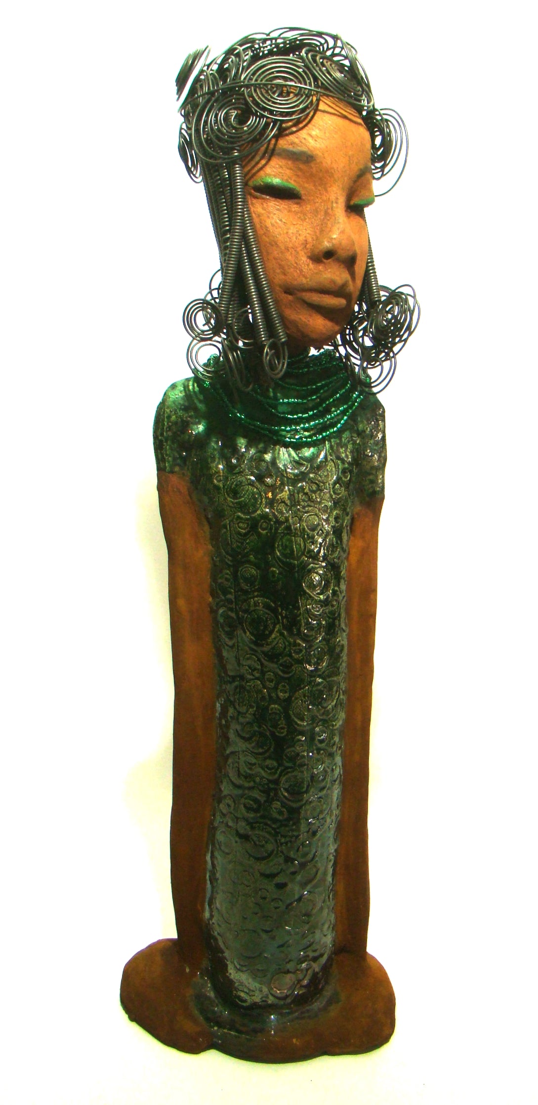 Felicia stands 25" x 8" x 6". and weighs 8.14 Lbs. She has a honey brown complexion with with over 40 feet of fancy wire hair. Felicia dress is textured alligator green. She wears emerald green bead. She really does have a sweet face.