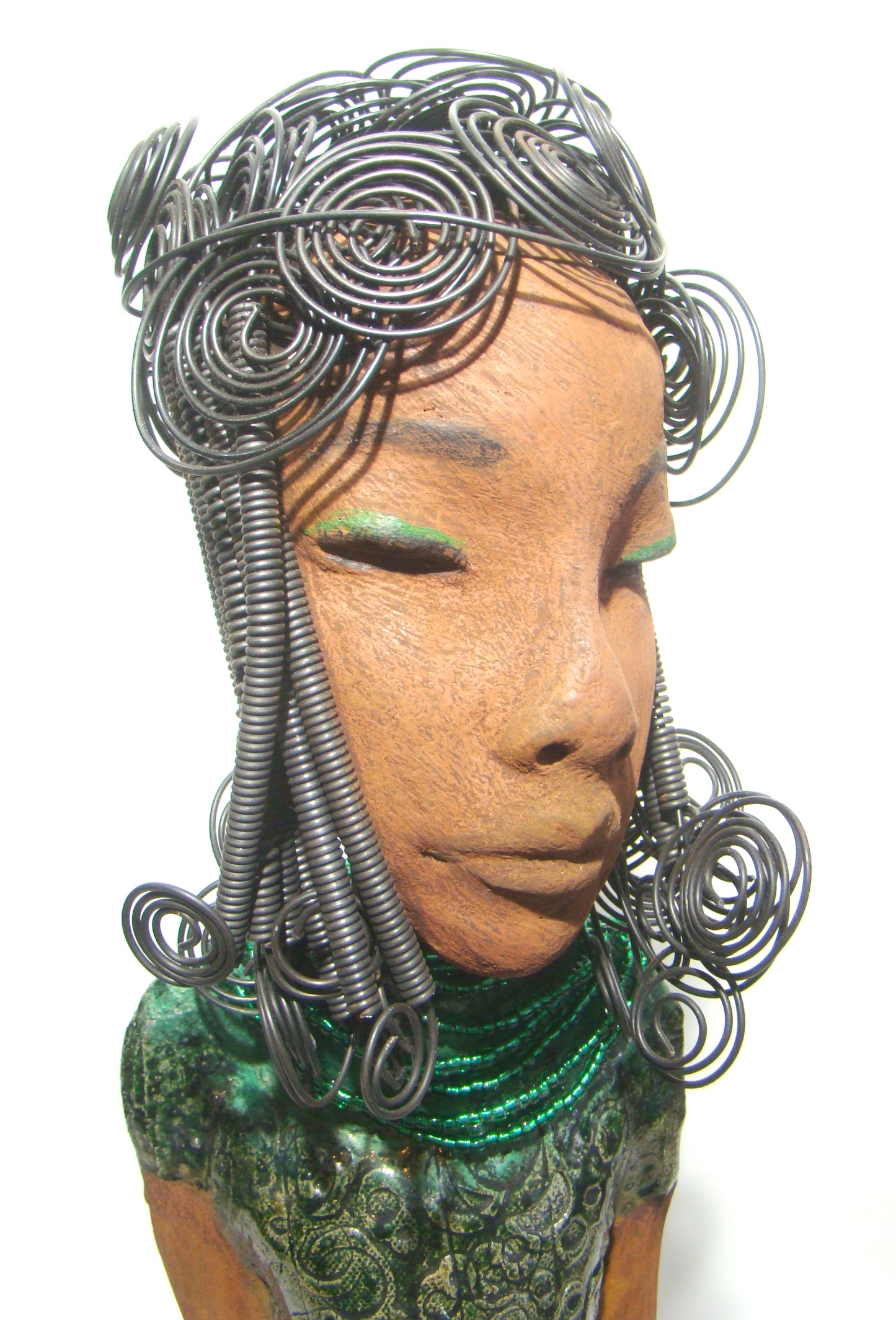 Felicia stands 25" x 8" x 6". and weighs 8.14 Lbs. She has a honey brown complexion with with over 40 feet of fancy wire hair. Felicia dress is textured alligator green. She wears emerald green bead. She really does have a sweet face.