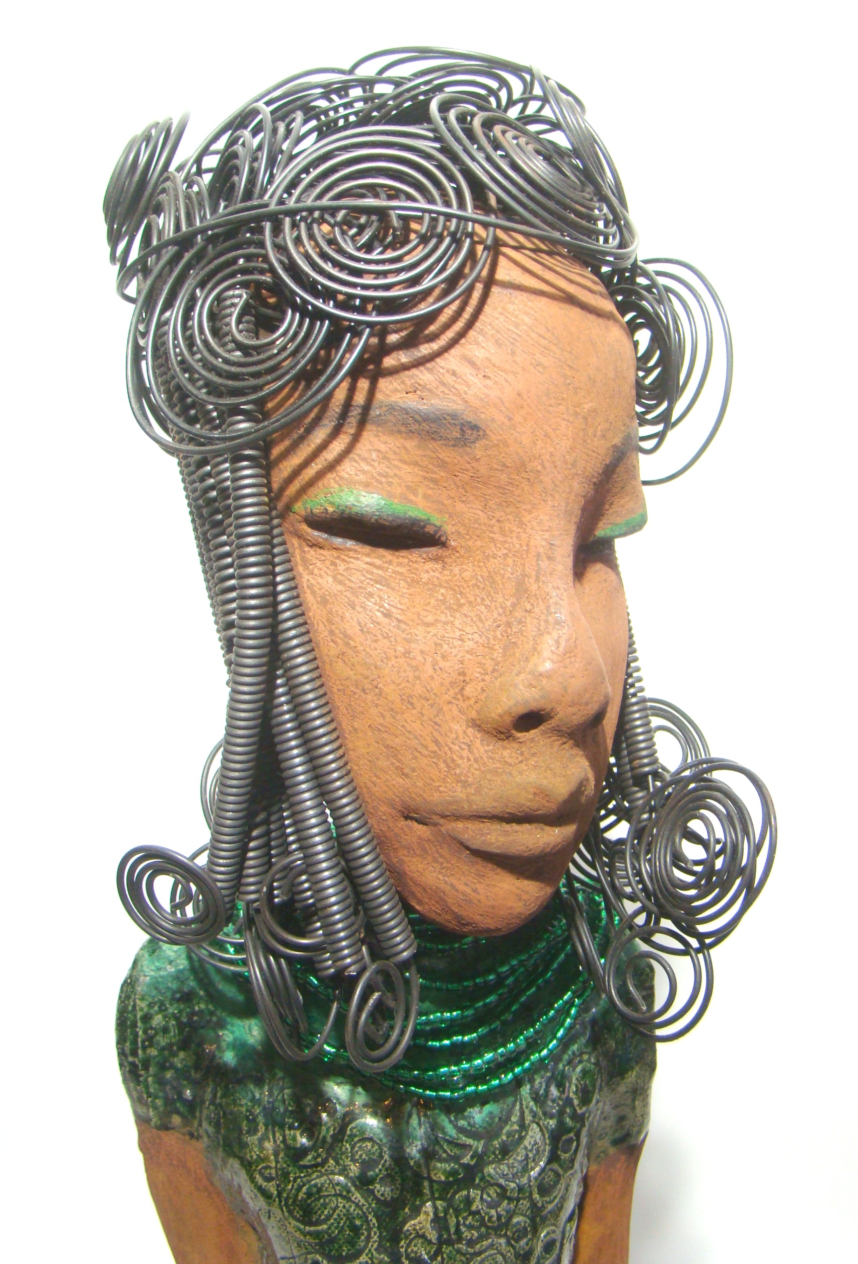 Felicia stands 25" x 8" x 6". and weighs 8.14 Lbs. She has a honey brown complexion with with over 40 feet of fancy wire hair. Felicia dress is textured alligator green. She wears emerald green bead. She really does have a sweet face.