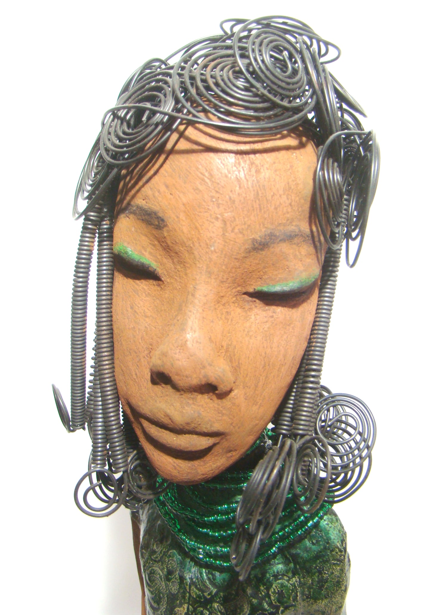 Felicia stands 25" x 8" x 6". and weighs 8.14 Lbs. She has a honey brown complexion with with over 40 feet of fancy wire hair. Felicia dress is textured alligator green. She wears emerald green bead. She really does have a sweet face.
