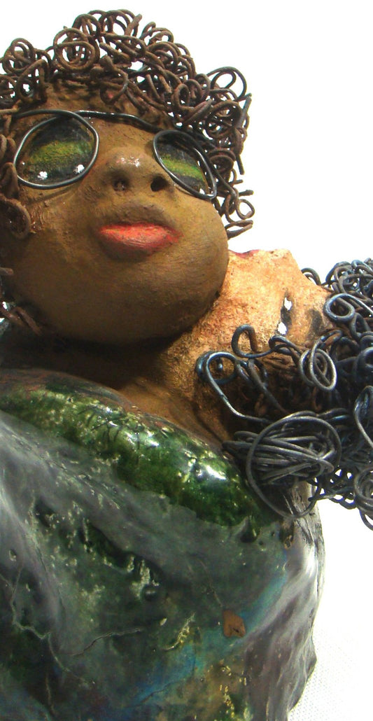 I Got You stands 10" x 6.5" x 6.5" and weighs 5.06 lbs.     They have lovely light beige and honey brown complexions.     Their dress are metallic green.     Combined I Got You has over 30 feet of curled 16 gauge wire.     The older of the two wears eyeglasses and seems to be the comforter.     I Got You will bring joy and happiness to your home.     Free Shipping!