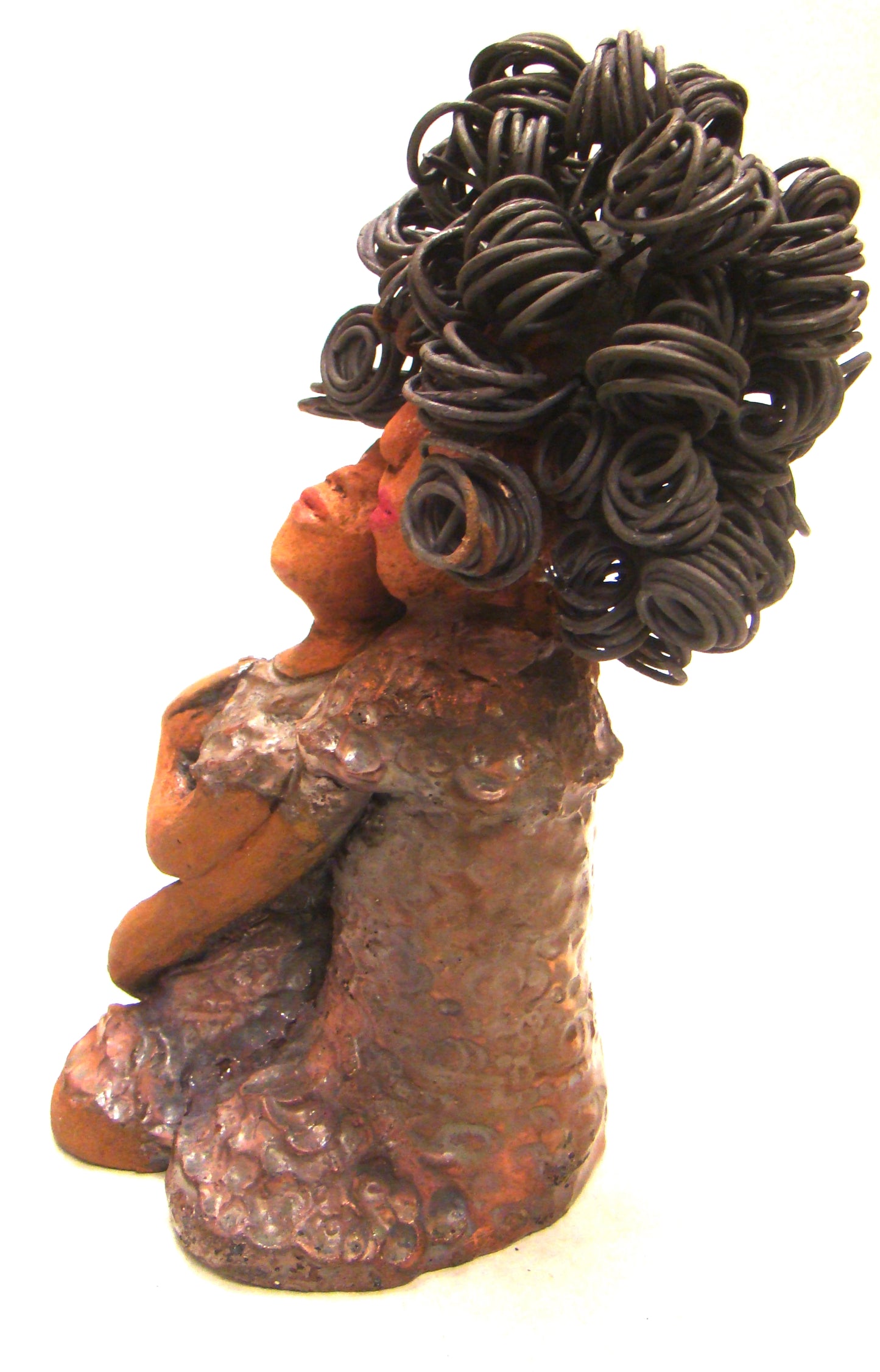 I Love You More stands 8.5 " x 4.5" x 4".5" and weighs 2.10 lbs. They have lovely honey brown complexions. Combined, I Love You More has over 25 feet of curly wire hair. They have glossy metallic copper dresses. They have long loving arms. One is embracing the other. I Love You More! will help illustrate the love that is in your home! Free Shipping!