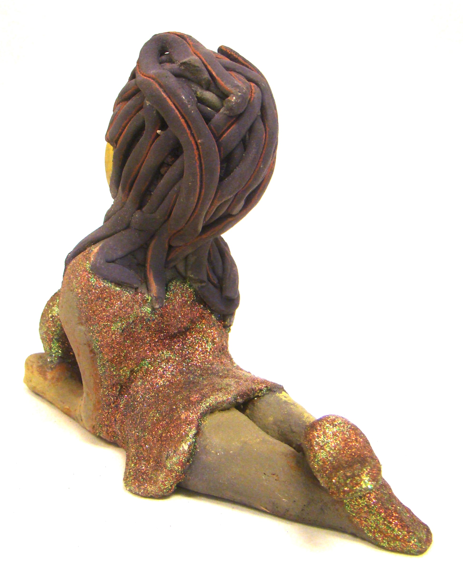 Lacey stands 6" x 3" x 7.5" and weighs 1.08 lbs. She has a lovely beige olive green complexions with ruby red lips. Her hair is made of coiled clay. Lacey is holding her handbag which matches her copper glittered dress. Give Lacey a special place in your home.