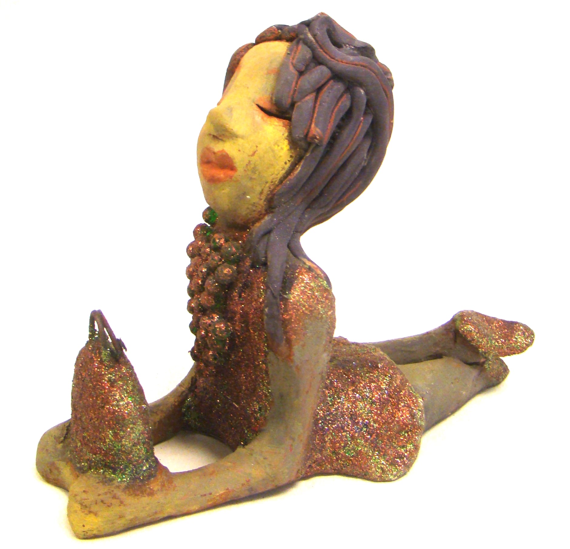 Lacey stands 6" x 3" x 7.5" and weighs 1.08 lbs. She has a lovely beige olive green complexions with ruby red lips. Her hair is made of coiled clay. Lacey is holding her handbag which matches her copper glittered dress. Give Lacey a special place in your home.
