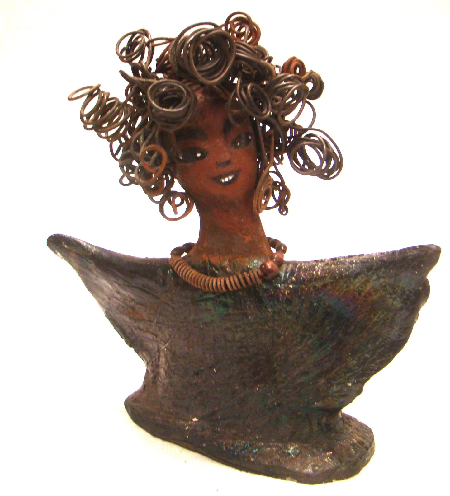 Harold stands 6" x 5" x 3" and weighs 8 ozs. He has a cocoa brown complexion with dreamy eyes. His hair is smokey gray and made of clay. Harold wears an extra large copper sweat shirt with a black collar. Harold is a great starter piece in the men Herdew collection.