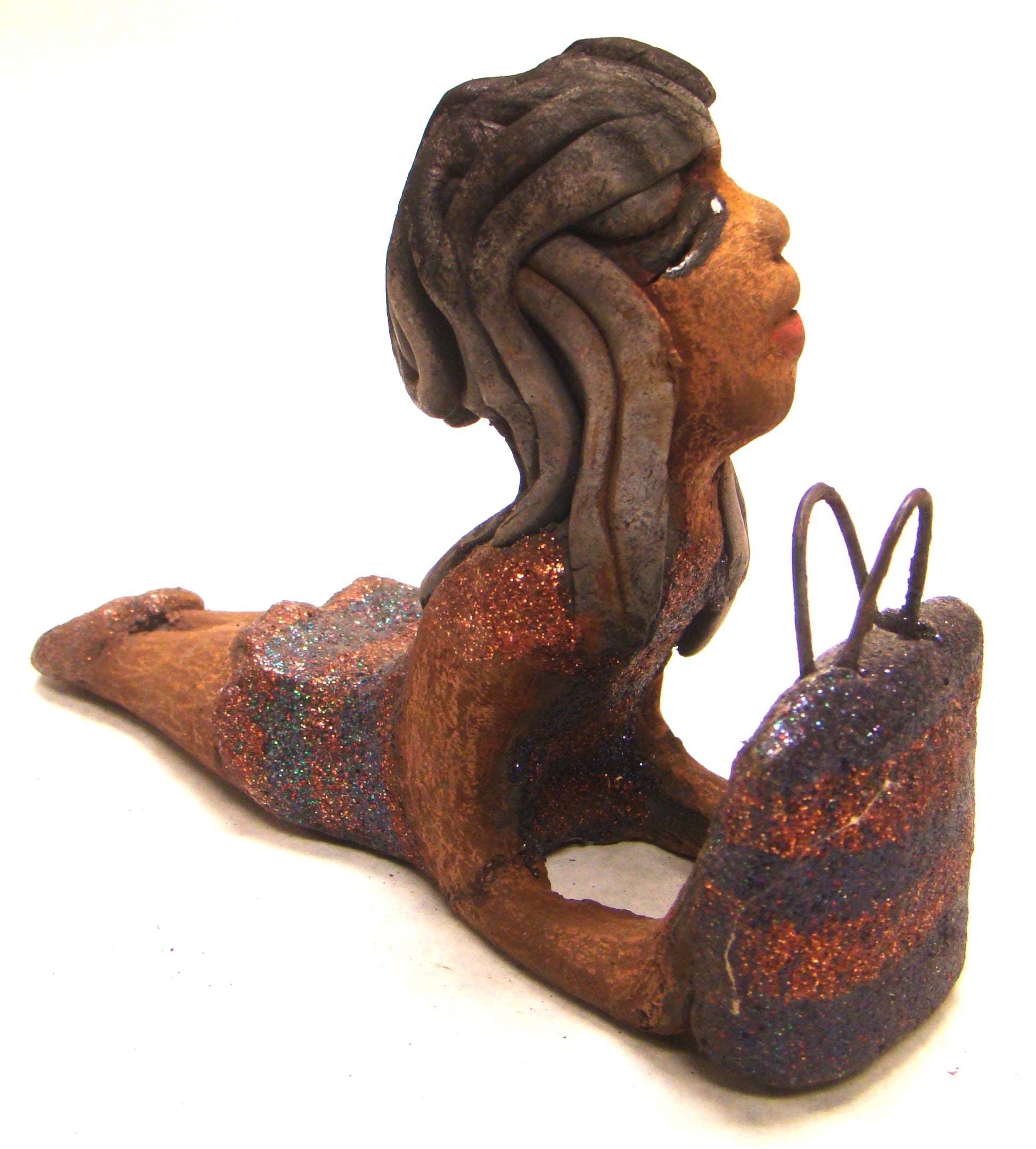 Wanda is Wishing and a Waiting !       Wanda stands 6" x 2.5" x 6" and weighs 11 ozs.     She has a lovely honey brown complexion with smokey gray clay hair.     Wanda's copper and green striped dress matches her bag.     Her long loving arms are outstretched with bag in hand.  Wanda is wishin and a waiting on You!