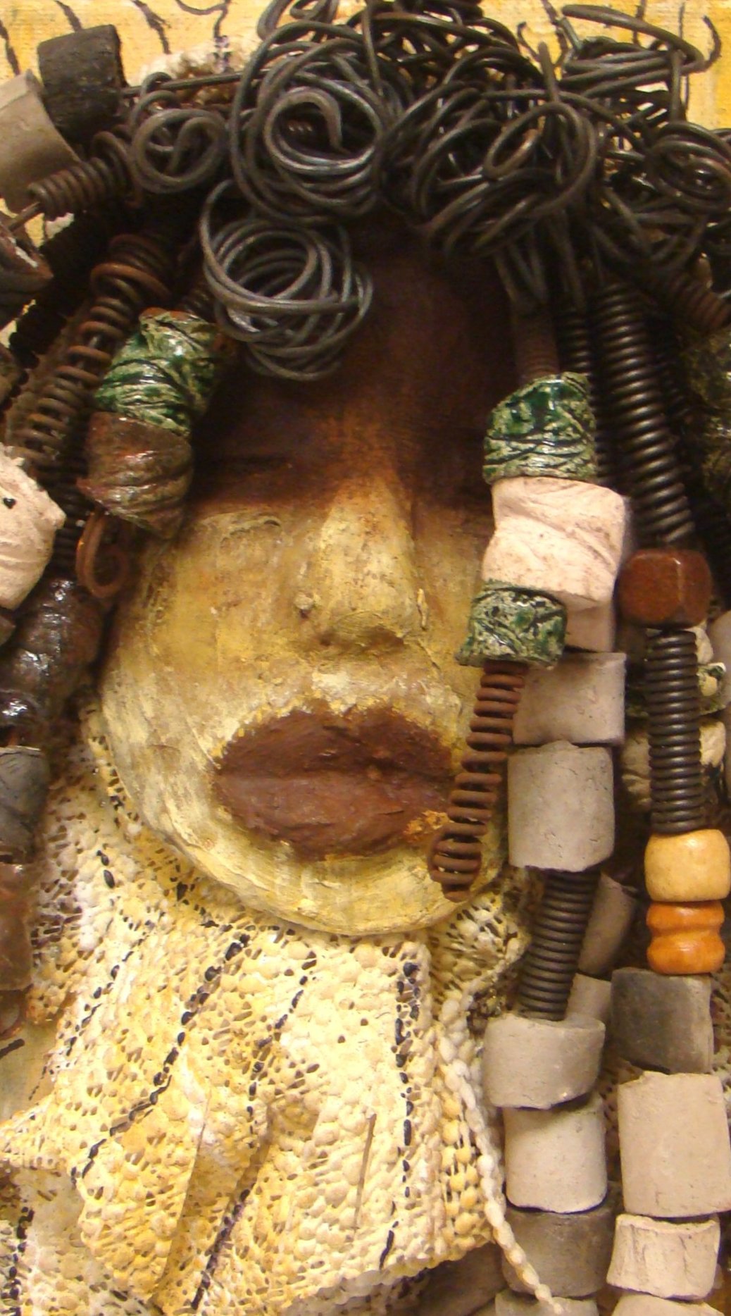 I started making mask after seeing an authentic African Mask collection at the Smithsonian Museum of African Art. I was in total awe. Millie was inspired by my visit there. Millie is mounted on a 9"x 12" painted canvas. I spent about 4 hours or more just  fixing Millie's hair and attaching her beads!      Millie has over 40 feet of 16 gauge wire for hair and over 50 raku beads.     Millie has a two tone  white chocolate crackle face with rust chocolate lips.     She is ready to be hung!   Free Shipping!