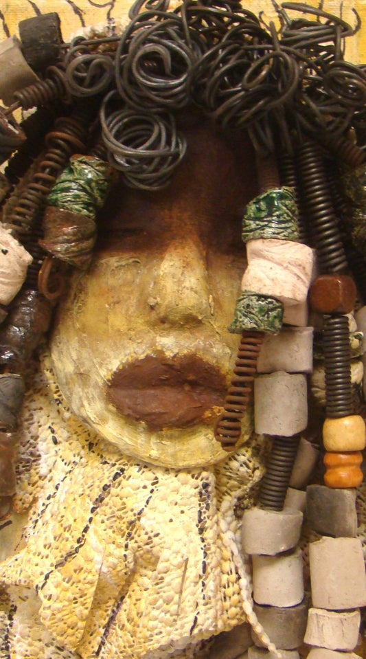 I started making mask after seeing an authentic African Mask collection at the Smithsonian Museum of African Art. I was in total awe. Millie was inspired by my visit there. Millie is mounted on a 9"x 12" painted canvas. I spent about 4 hours or more just  fixing Millie's hair and attaching her beads!      Millie has over 40 feet of 16 gauge wire for hair and over 50 raku beads.     Millie has a two tone  white chocolate crackle face with rust chocolate lips.     She is ready to be hung!   Free Shipping!