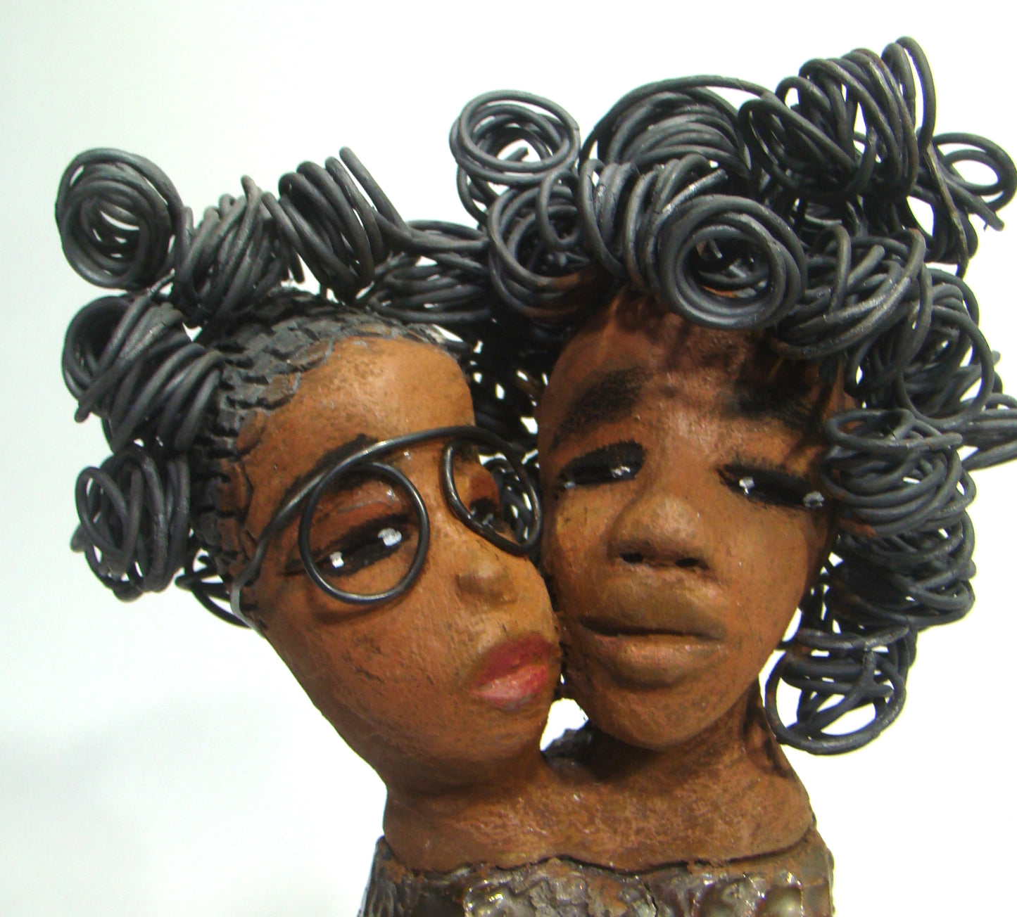 My BFF stands 13" x 8" x 4" and weighs 4.13 lbs. Both girls have lovely honey brown complexions. Their dresses are textured and have copper metallic glazes. The long loving arms of My BFF embrace one another with love. My BFF has over 25 feet of curly 16 gauge wire hair. My BFF represents the close bond and friendship that has developed between all women of every race, ethnicity, and color. My BFF will make an excellent gift to your BFF! Free Shipping!