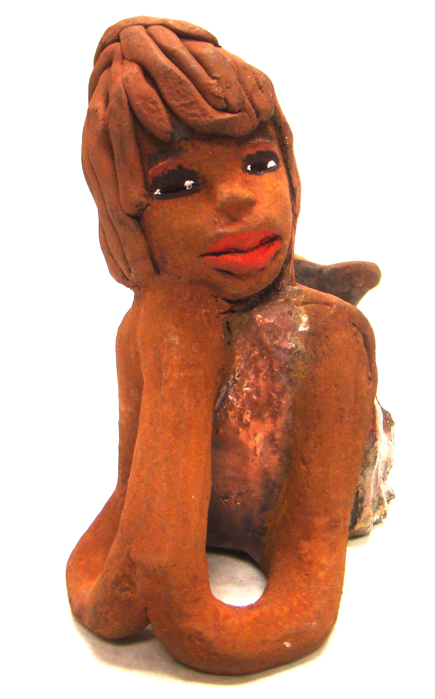 Ada stands 6" x 3.5" x 7.5" and weighs 1.11 lbs. Ada has a lovely honey brown complexion with ruby red lips.. Her long loving arms are underneath her face as she ponders. Ada dress is a copper glazed and she has hair made of clay. Ada is bright eyed and ready to be placed in a good home.