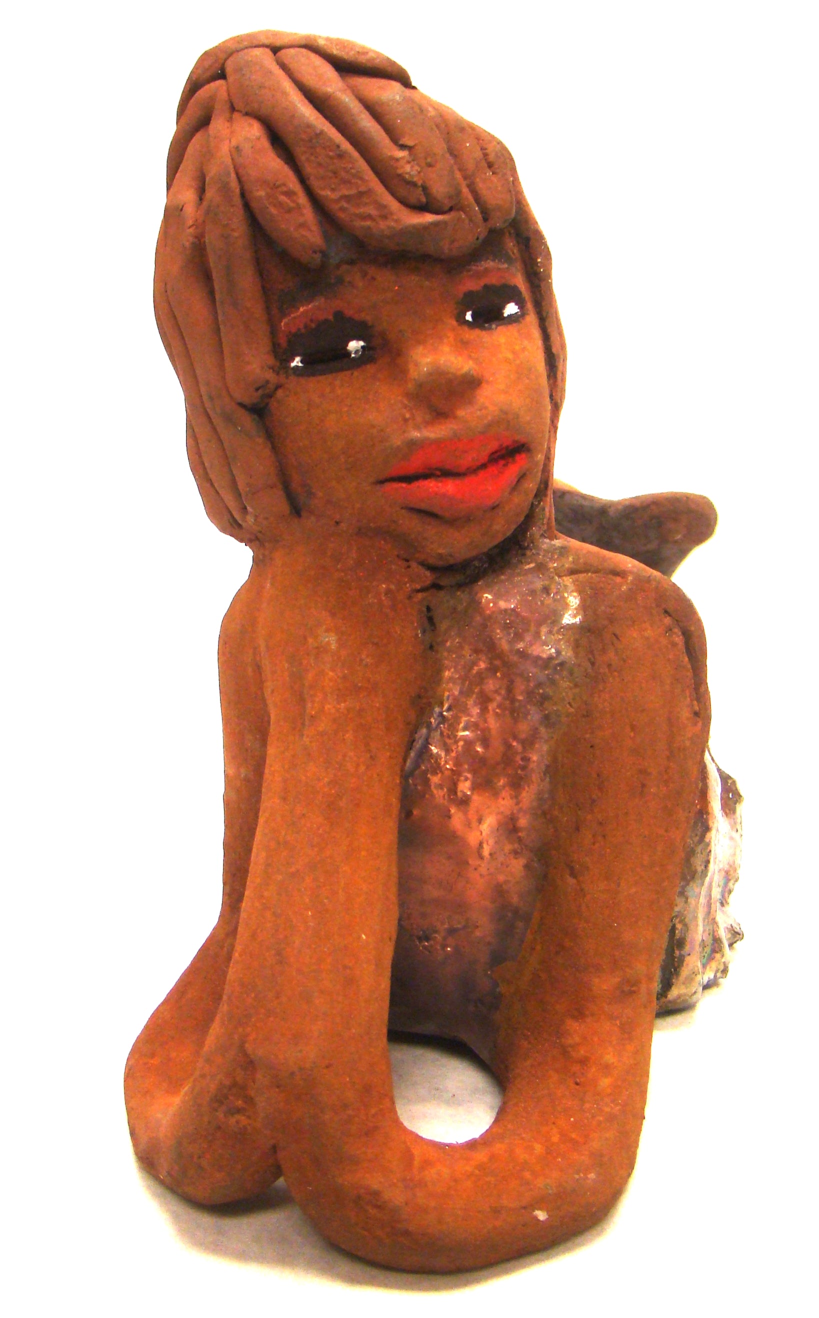 Ada stands 6" x 3.5" x 7.5" and weighs 1.11 lbs.     Ada has a lovely honey brown complexion with ruby red lips..     Her long loving arms are underneath her face as she ponders.     Ada dress is a copper glazed and she has hair made of clay.     Ada is bright eyed and ready to be placed in a good home.