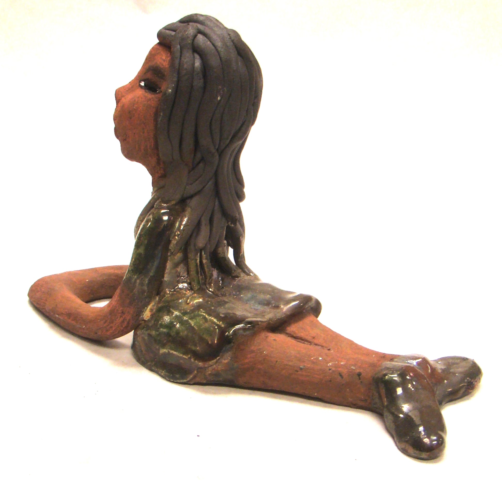 Meet Ashlie!      Ashlie stands 6" x 3" x 8.5" and weighs 1.6 lbs.     Ashlie has a lovely copper brown complexion and smokey black hair.     She wears a metallic copper dress and shoes.     Her long loving arms are placed in front of her as she rest.  Give Ashlie a nice spot to relax in your home!