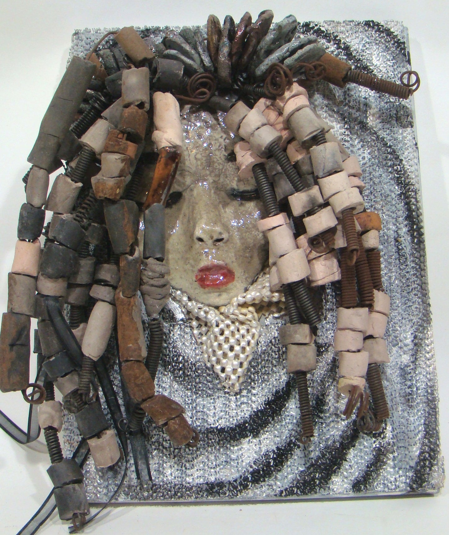 She has over 30 feet of 16 gauge wire for hair and over 60 raku beads. Reagan has a white crackle face with ruby red lips. She is ready to be hung!