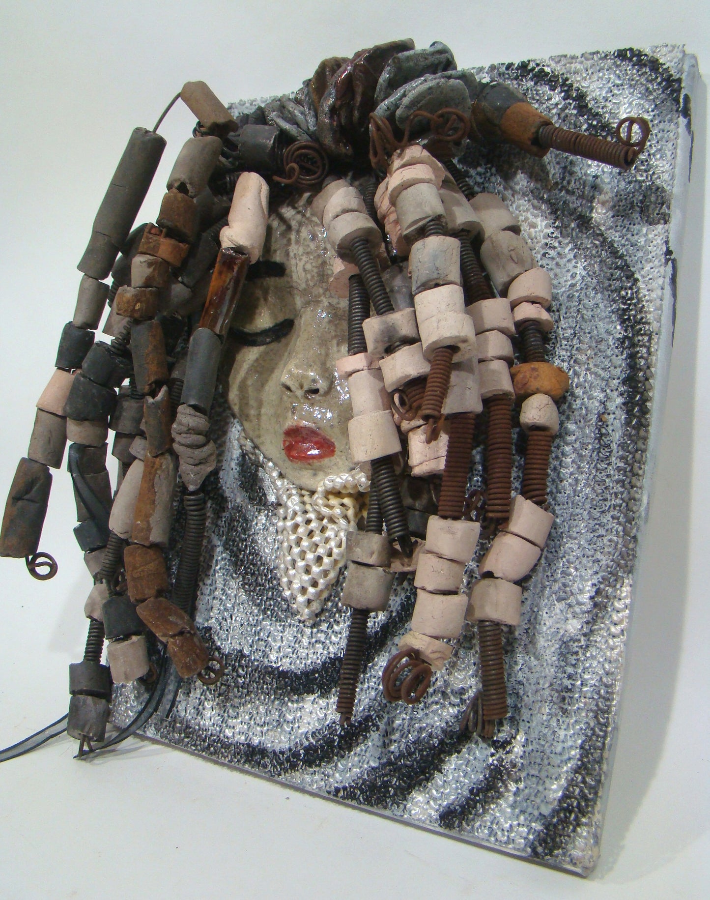 She has over 30 feet of 16 gauge wire for hair and over 60 raku beads. Reagan has a white crackle face with ruby red lips. She is ready to be hung!