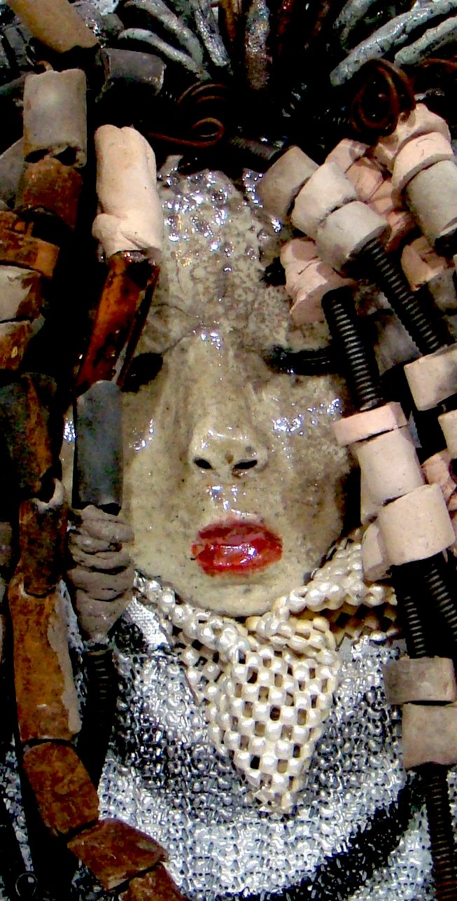 She has over 30 feet of 16 gauge wire for hair and over 60 raku beads. Reagan has a white crackle face with ruby red lips. She is ready to be hung!