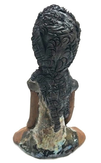Meet Brenda!      Brenda stands &' x 4" x 2.5" and weighs 11 ozs.     She has a lovely honey brown complexion.     Brenda wears a metallic green dress.     Her hair is smokey black.and made of clay.     Brends's long loving arms rest at her side.  Brenda will make a great gift or a starter piece from the Herdew Collection!