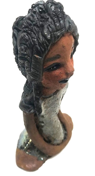 Meet Brenda!      Brenda stands &' x 4" x 2.5" and weighs 11 ozs.     She has a lovely honey brown complexion.     Brenda wears a metallic green dress.     Her hair is smokey black.and made of clay.     Brends's long loving arms rest at her side.  Brenda will make a great gift or a starter piece from the Herdew Collection!