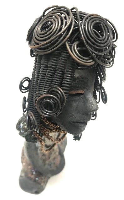 Meet Carolyn!      Carolyn stands 12" x 6" x 4" and weighs 2.4 lbs.     Carolyn as a lovely smokey dark complexion with honey brown eye shadow.'     She wears a textured glossy copper metallic dress.     Carolyn's long loving arms are at her side.     It took three hours to complete her 16 gauge wire Herdew!  Give Carolyn a special place in your home Free Shipping!