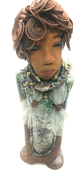 Meet Dorothy!      Dorothy states 15" x 5" x 3 and weighs 2.7 lbs     She has a lovely honey brown complexion.     Dorothy wears a green metallic dress with a beaded tulle around her neck.     It took over 3 hours to complete Dorothy's Herdew.     The hair is made of 16 gauge wire.     Dorothy long loving arms are at her sides.  Give Dorothy as a special gift or a special place in your home.