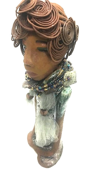 Meet Dorothy!      Dorothy states 15" x 5" x 3 and weighs 2.7 lbs     She has a lovely honey brown complexion.     Dorothy wears a green metallic dress with a beaded tulle around her neck.     It took over 3 hours to complete Dorothy's Herdew.     The hair is made of 16 gauge wire.     Dorothy long loving arms are at her sides.  Give Dorothy as a special gift or a special place in your home.