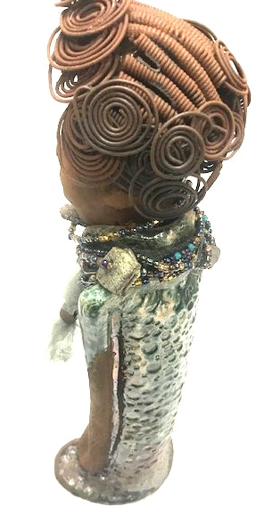 Meet Dorothy!      Dorothy states 15" x 5" x 3 and weighs 2.7 lbs     She has a lovely honey brown complexion.     Dorothy wears a green metallic dress with a beaded tulle around her neck.     It took over 3 hours to complete Dorothy's Herdew.     The hair is made of 16 gauge wire.     Dorothy long loving arms are at her sides.  Give Dorothy as a special gift or a special place in your home.