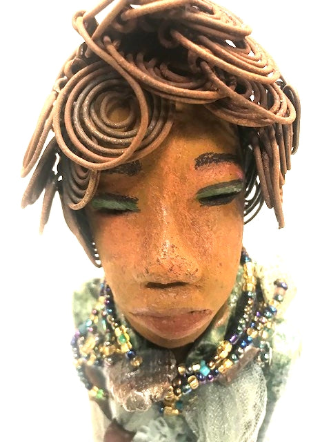 Meet Dorothy!      Dorothy states 15" x 5" x 3 and weighs 2.7 lbs     She has a lovely honey brown complexion.     Dorothy wears a green metallic dress with a beaded tulle around her neck.     It took over 3 hours to complete Dorothy's Herdew.     The hair is made of 16 gauge wire.     Dorothy long loving arms are at her sides.  Give Dorothy as a special gift or a special place in your home.
