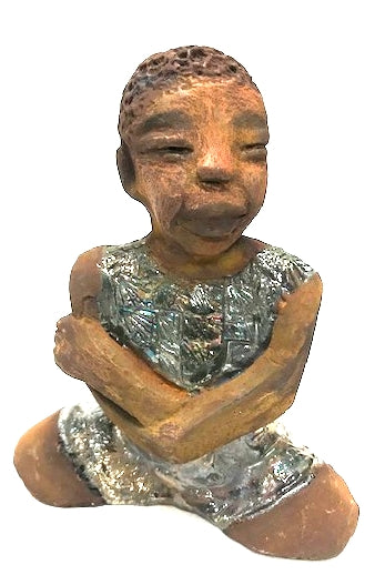 Eddie is a Wise Guy! See the wisdom in his face? Eddie stands 7" x 6" x 3" and weighs 1 lb. He has a shimmery copper over-sized shirt. Eddie complexion is honey brown. His arms are folded as he ponders!