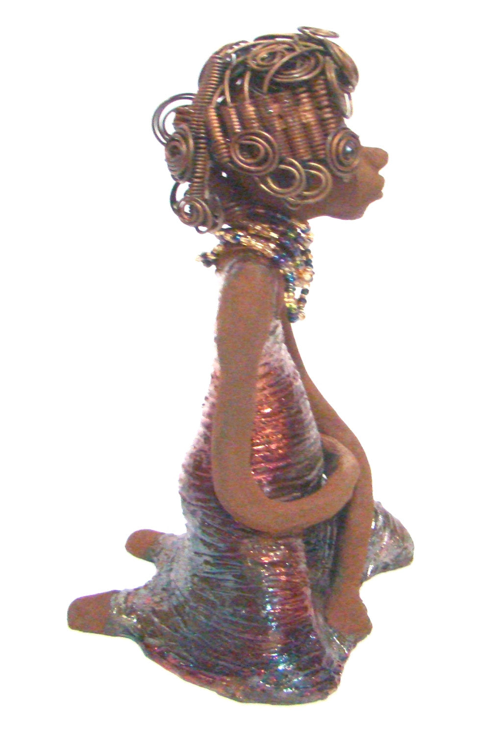 Gloria  is a raku fired and stands 12" x 7" x 5" and weighs 2.1lbs. She has a lovely brown complexion. Gloria's hair is gold and black. It took over 3 hours and 40 feet of coils and spiral 16 guage wire to complete.