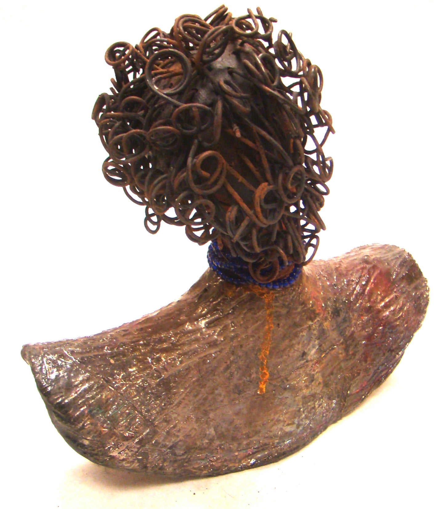 Helen stands 8" x 8" x 3" and weighs 2.06 lbs. She has a lovely honey brown complexion. Helen has a metallic copper glaze on her textured robe. Her blue eye shadow matches the blue strand of beads around her neck. Helen has over 20 feet of curly wire hair. Helen is somewhat angelic! Give Helen a prominent place in your home!