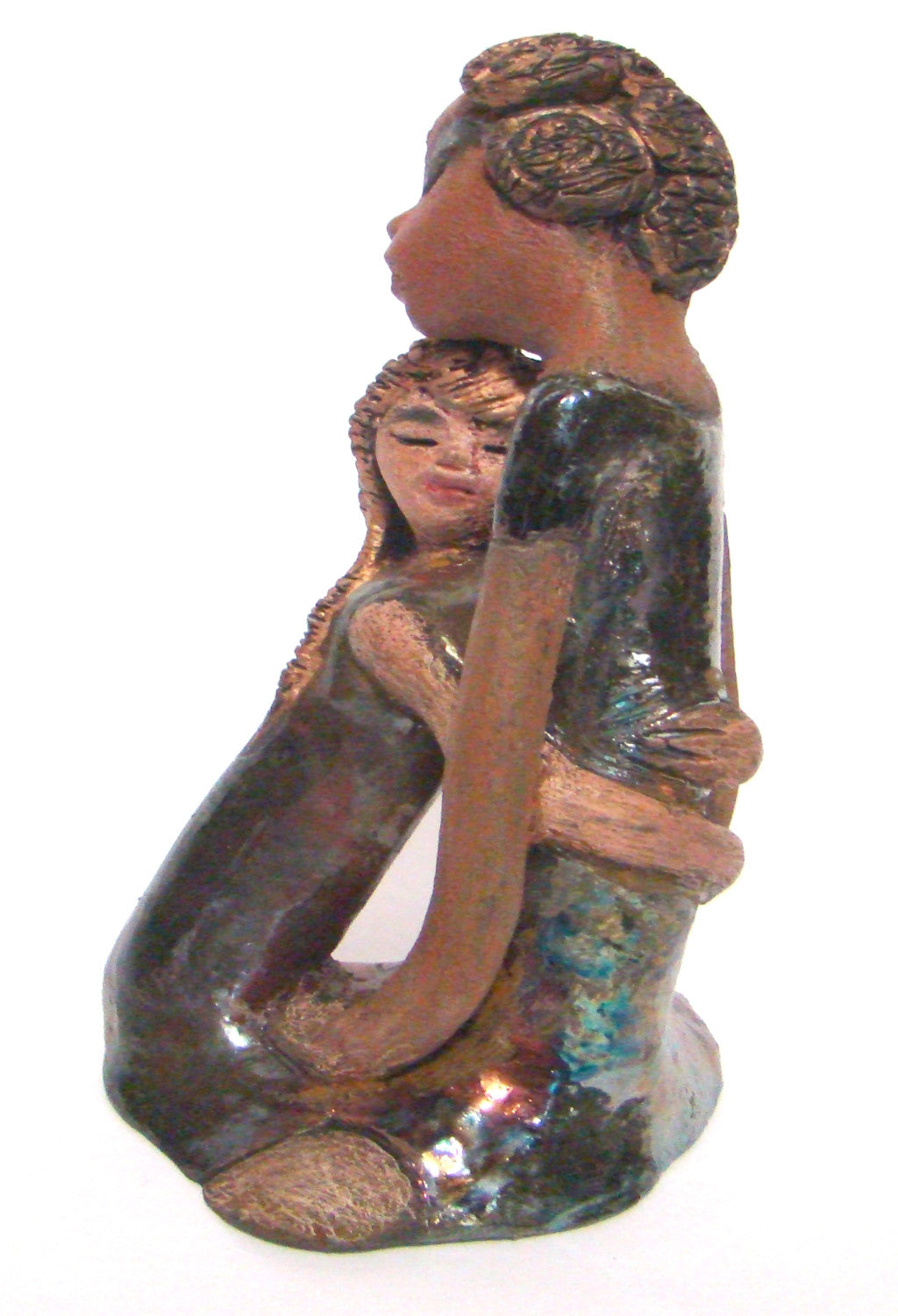 Hold Me Mama depicts the bond between a mother and child. They stand 10" x 5" x 5" and weighs 2.8 lbs. Mother and Child has honey brown complexions with etched...