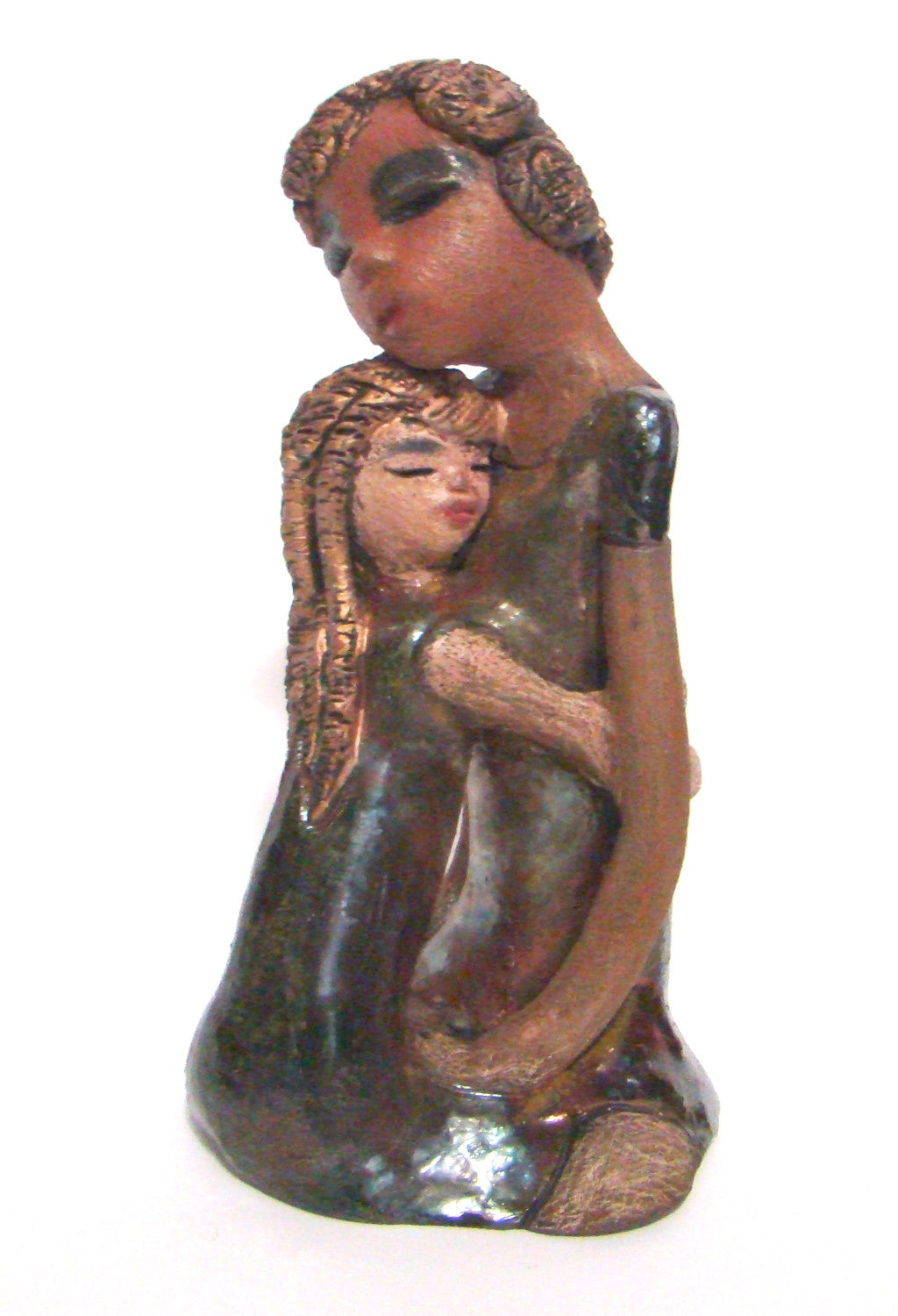 Hold Me Mama depicts the bond between a mother and child. They stand 10" x 5" x 5" and weighs 2.8 lbs. Mother and Child has honey brown complexions with etched...