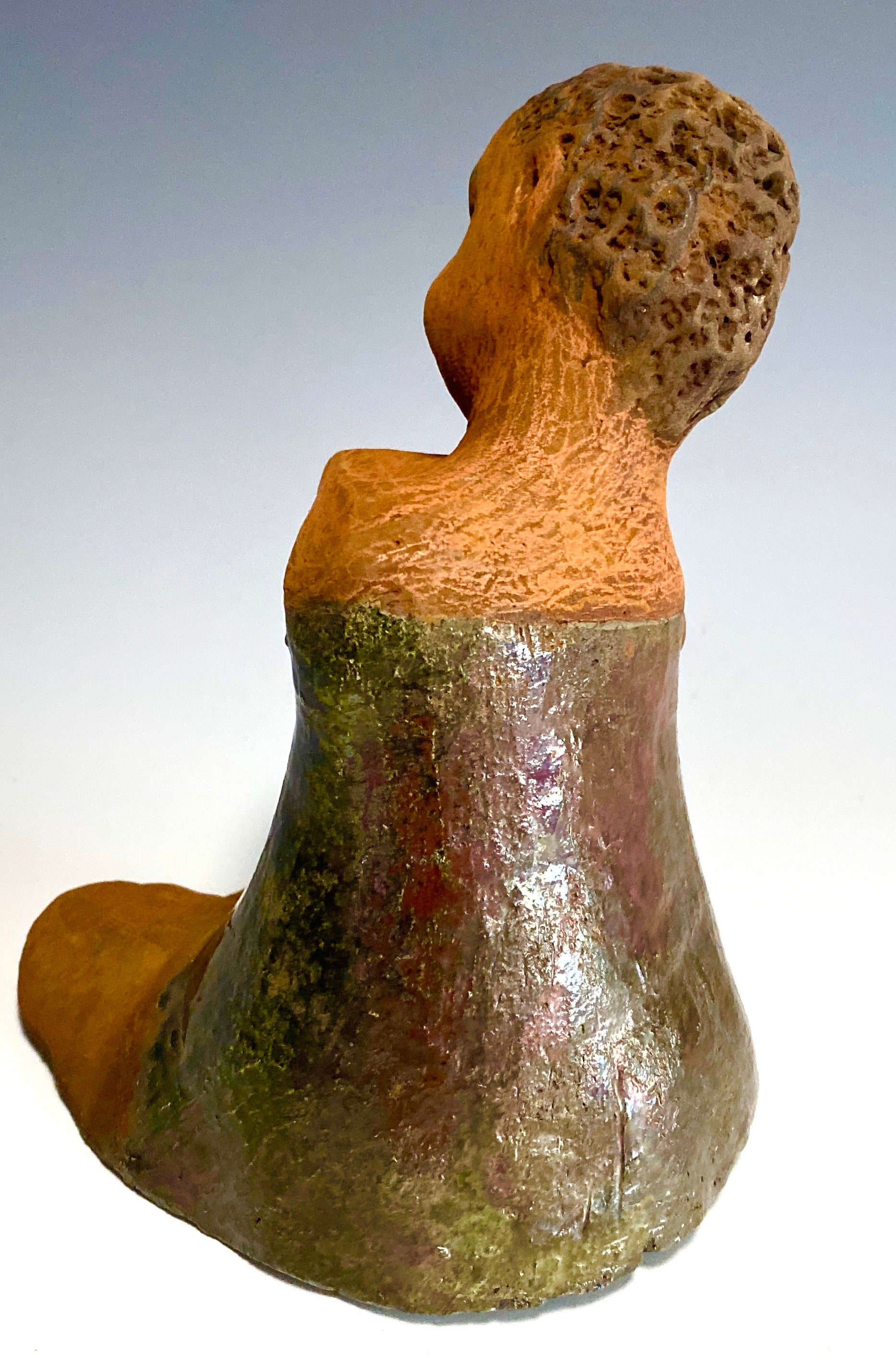 Carlos is one teen who will think before he reacts!   Carlos stands  6.5" x 4" x 5" and weighs 1.7 lbs. He wears a matching metallic green shirt and jeans . Carlos complexion is honey brown. He is thoughtful with a gentle spirit His  arms  are wrapped around  his knees as he waits on you.