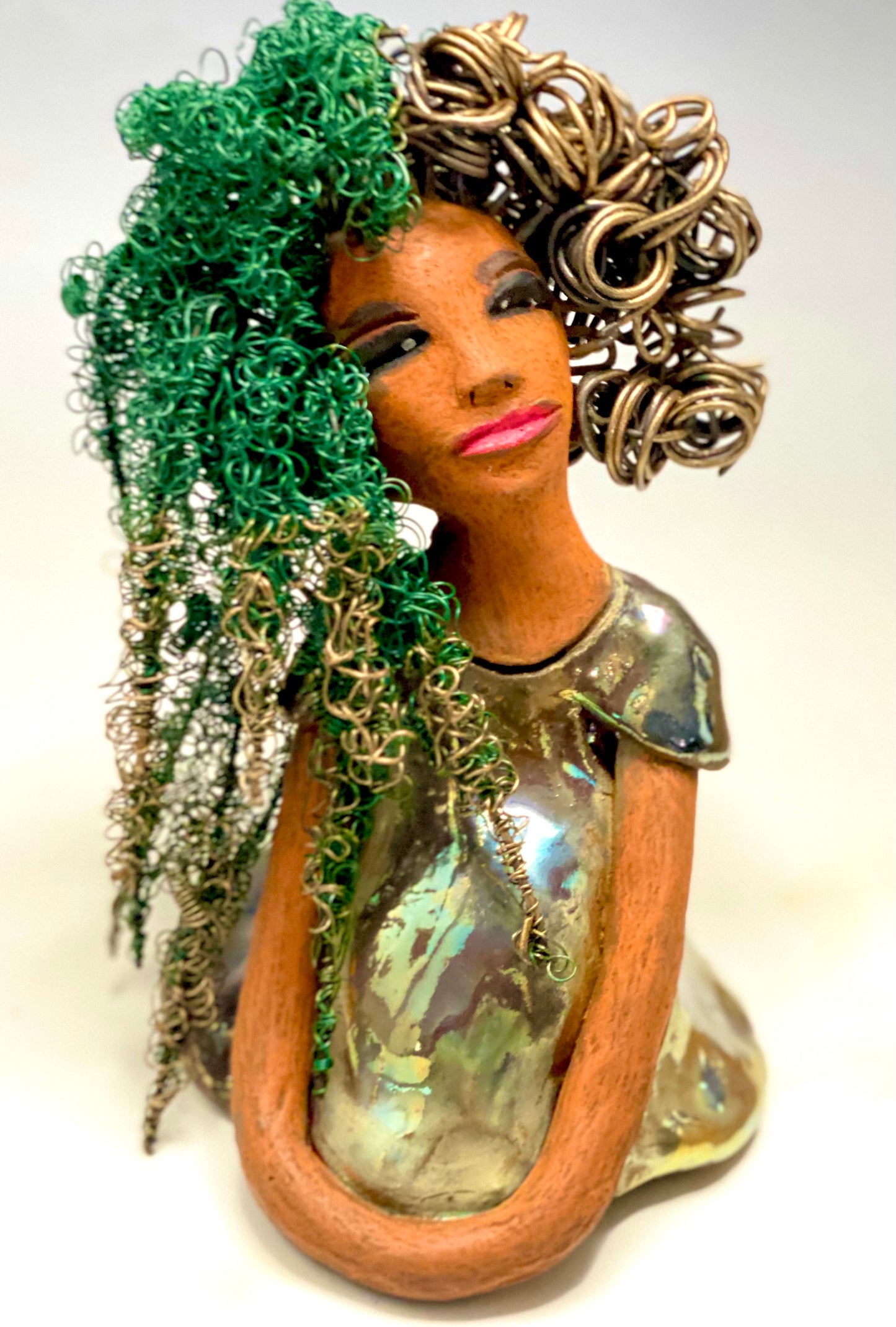 Diane stands 7" x 6" x 5.5" and weighs 1.9 lbs. She has a lovely honey brown complexion with reddish brown lips. She has long twisted wire locs hairstyle waist down! Diane has a very colorful metallic copper green antique glazed dress. She has over 75 feet of 16 and 24 gauge wire for hair. It took over 6 hours just to do her hair! With eyes wide opened, Diane has hope of finding a new home.
