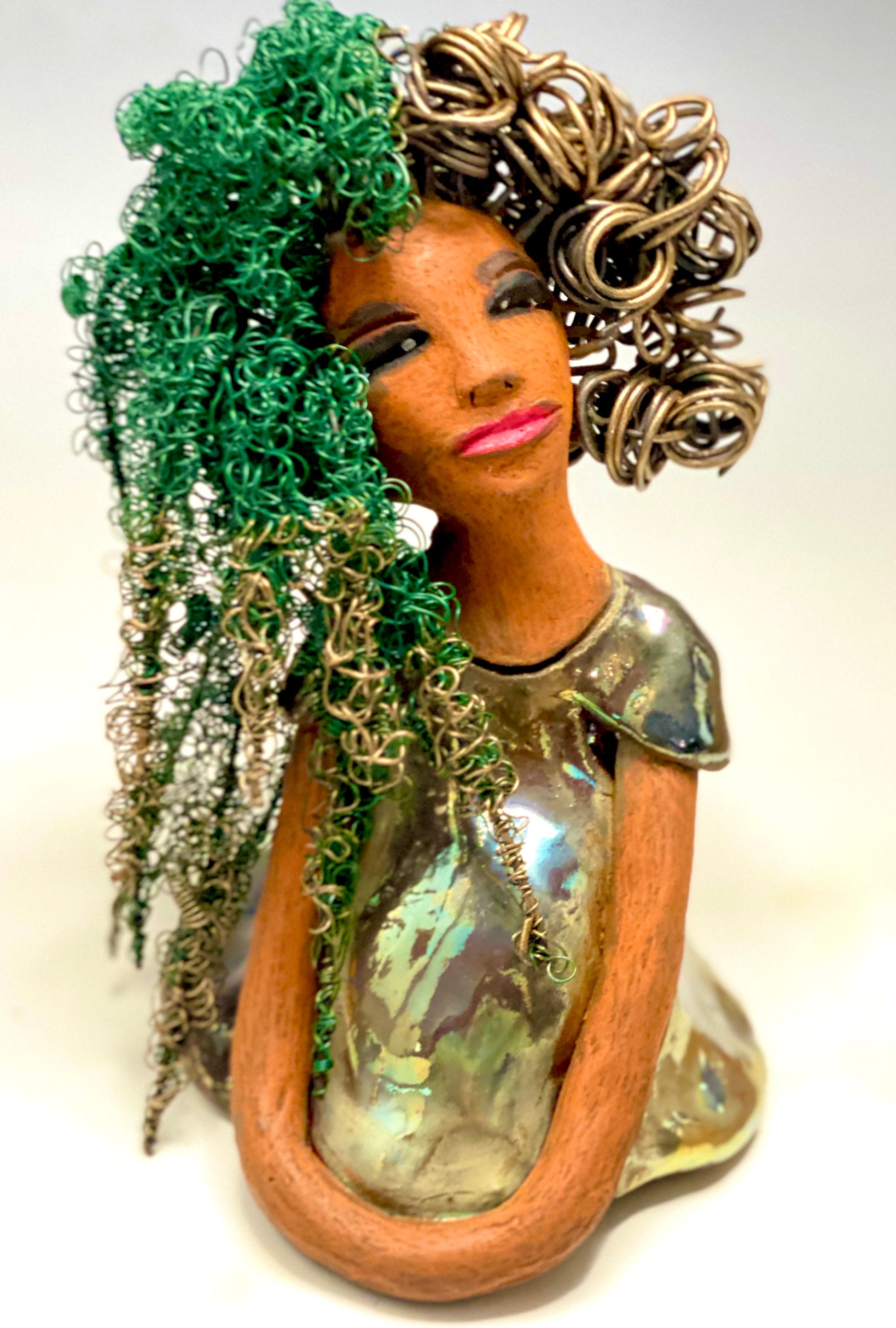 Diane stands 7" x 6" x 5.5" and weighs 1.9 lbs. She has a lovely honey brown complexion with reddish brown lips. She has long twisted wire locs hairstyle waist down!  Diane has a very colorful metallic  copper green antique glazed dress. She has over 75 feet of 16 and 24 gauge  wire for hair. It took over 6 hours just to do her hair! With  eyes wide opened, Diane has hope of finding a new home.