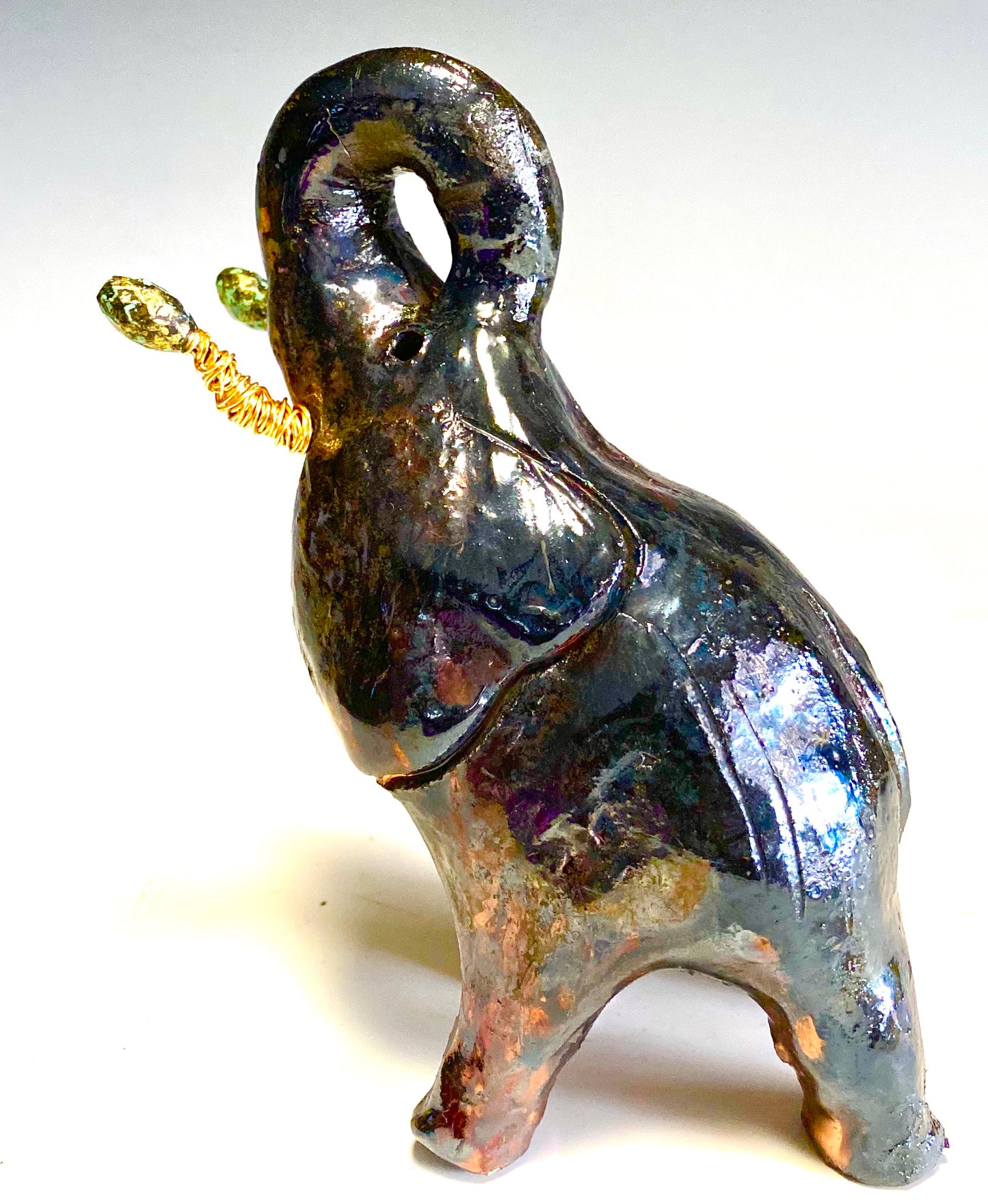 Raku Elephant Have you HERD!!!!!! Just one of these lovely Raku Fired Elephant will make an excellent gift for your friend, sorority or for your home’ special place centerpiece. 6" x 4" x 3" 13 ozs. Beautiful dark copper metallic raku elephant For decorative purposely only.