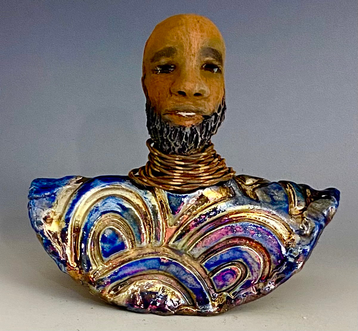 In Memory of Dr. Martin Luther King April 4, 1968 and the Civil Rights Movement. I Am a Man is a declaration of civil rights, often used as a personal statement and as a declaration of independence against oppression. I am a Man stands 7" x 7" x 3.5" and weighs 1.5lbs. I am a Man wears a colorful metallic gold, blue and copper dashiki. He is bald and bearded. Yes ,,,,,,He is one of few Men found in the Herdew collection!