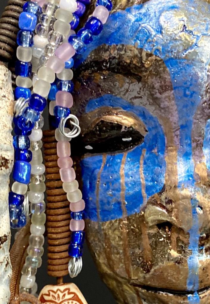 I started making mask soon after seeing authentic African artwork at the Smithsonian Museum of African Art. I was in total awe. I was inspired by my visit there.. Haze has a multi colored blue tone metallic copper complexion. She is 7" x 5" and weighs 10 ozs. Haze has over 50 mini beads and handmade raku beads. Haze has over 4 feet of 16 gauge wire hair.