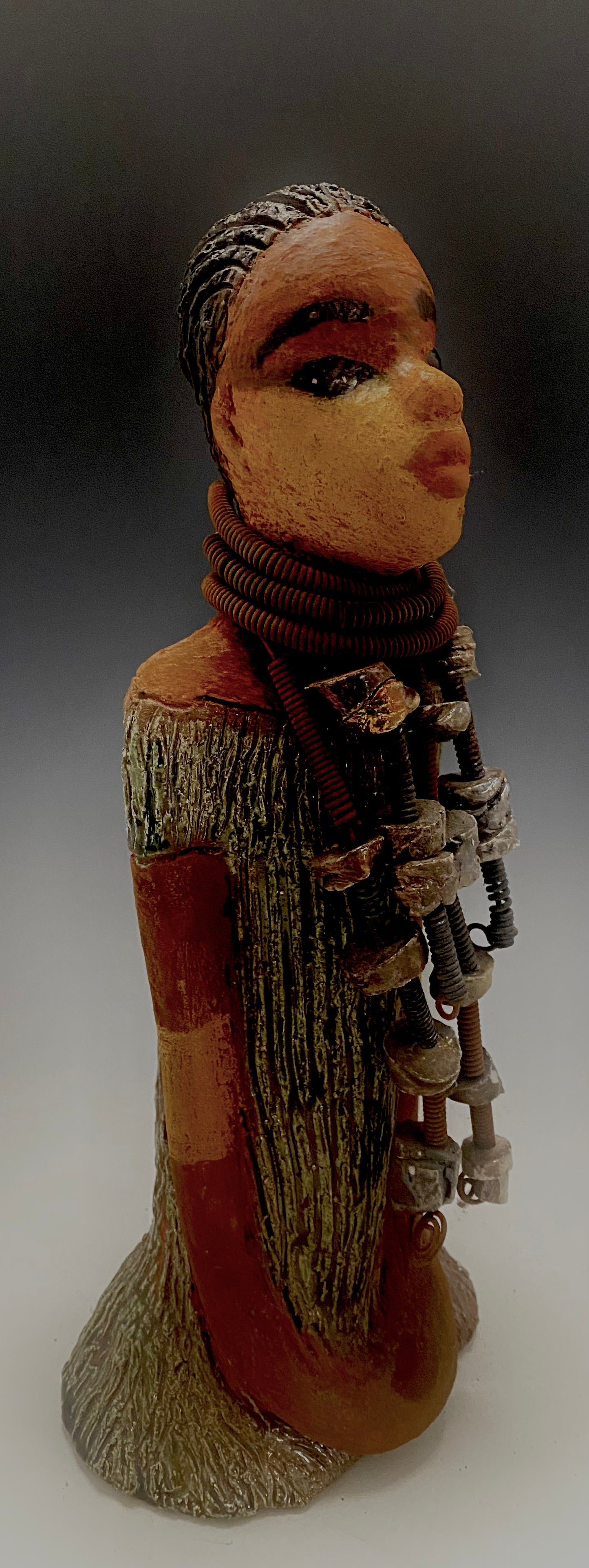 Meet Jana J! Jana J stands 13" x 6" x 5" and weighs 3.09 lbs Jana has a lovely two tone honey brown complexion. She wears a long strand of raku beads around her neck. Give Jana J in a special place in your home!