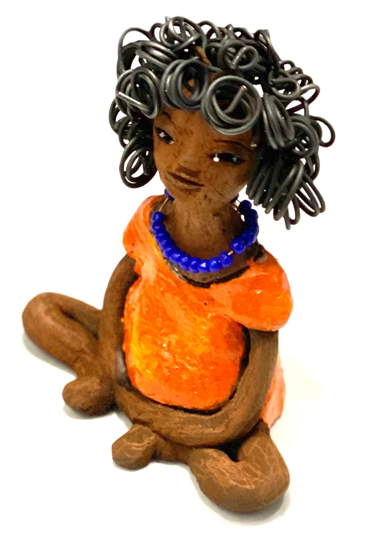Asia stands 5" x 4" x 3.5" and weighs 8.75 ozs. She has a lovely honey brown complexion with cocoa brown lips. She has a really big curly hairstyle! Asia has beautiful a orange dress dress accented with a blue beaded necklace! . She has over 15 feet of 16 gauge wire for hair. It took over 2 hours just to do her hair! With eyes wide opened, Asia has hope of finding a new home.