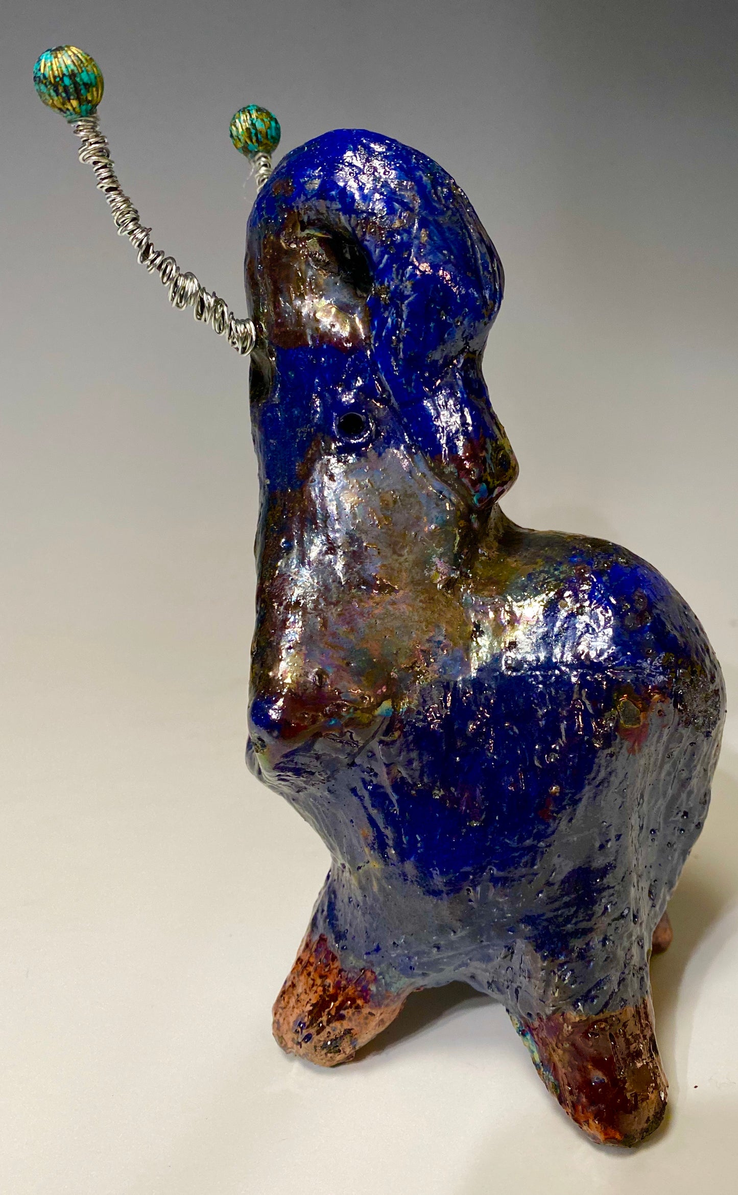 Have you HERD!!!!!! Just one of these lovely Raku Fired Elephant will make an excellent gift for your friend, sorority or for your home’ special place centerpiece. 7" x 4" x 4" 15 ozs. Silver wire beaded blue tusk Beautiful metallic blue raku colors For decorative purposely only.