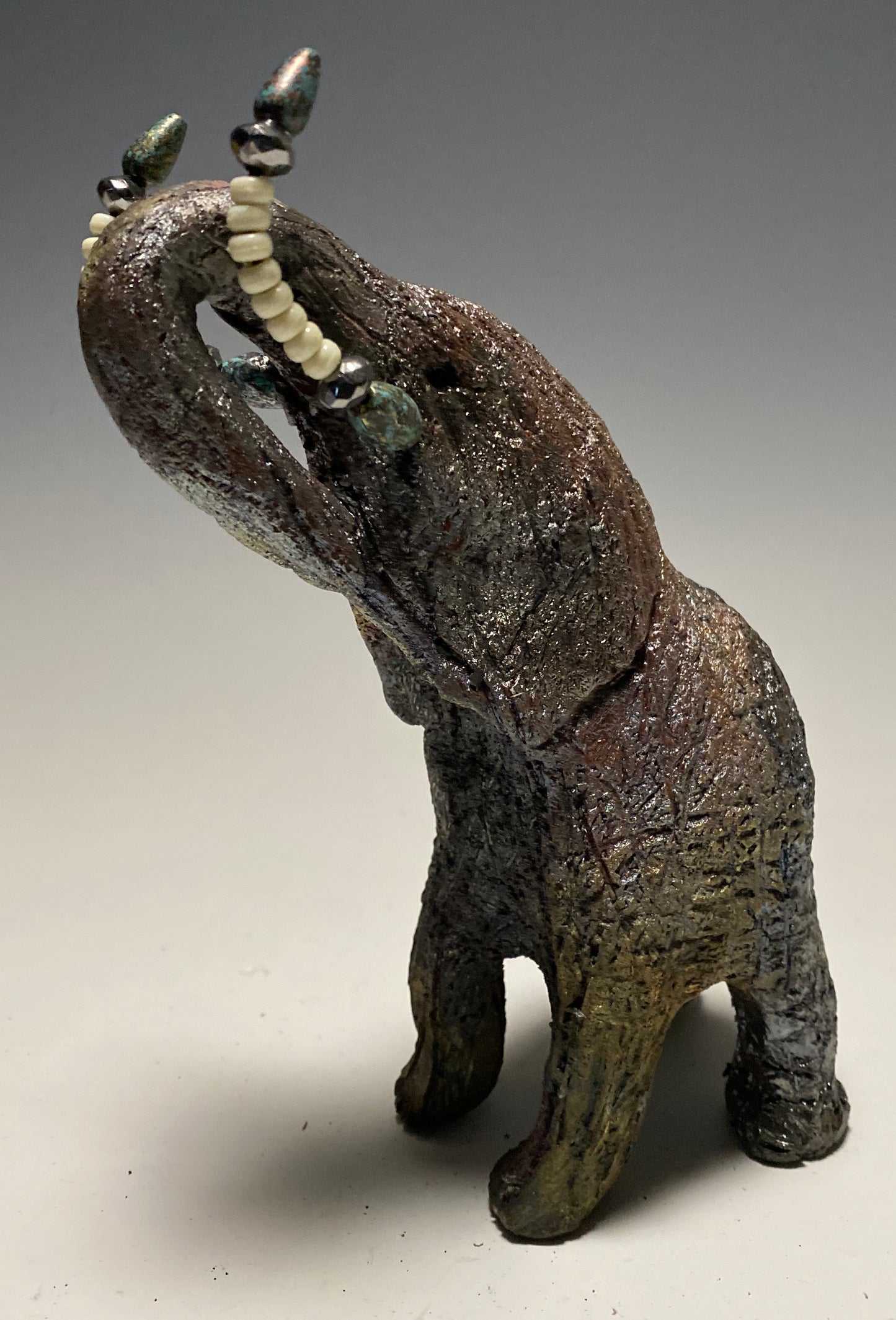 Raku Elephant Have you HERD!!!!!! Just one of these lovely Raku Fired Elephant will make an excellent gift for your friend, sorority or for your home’ special place centerpiece. 7" x 4" x 4" 1 lbs Beautiful colorful metallic matte raku elephant For decorative purposely only
