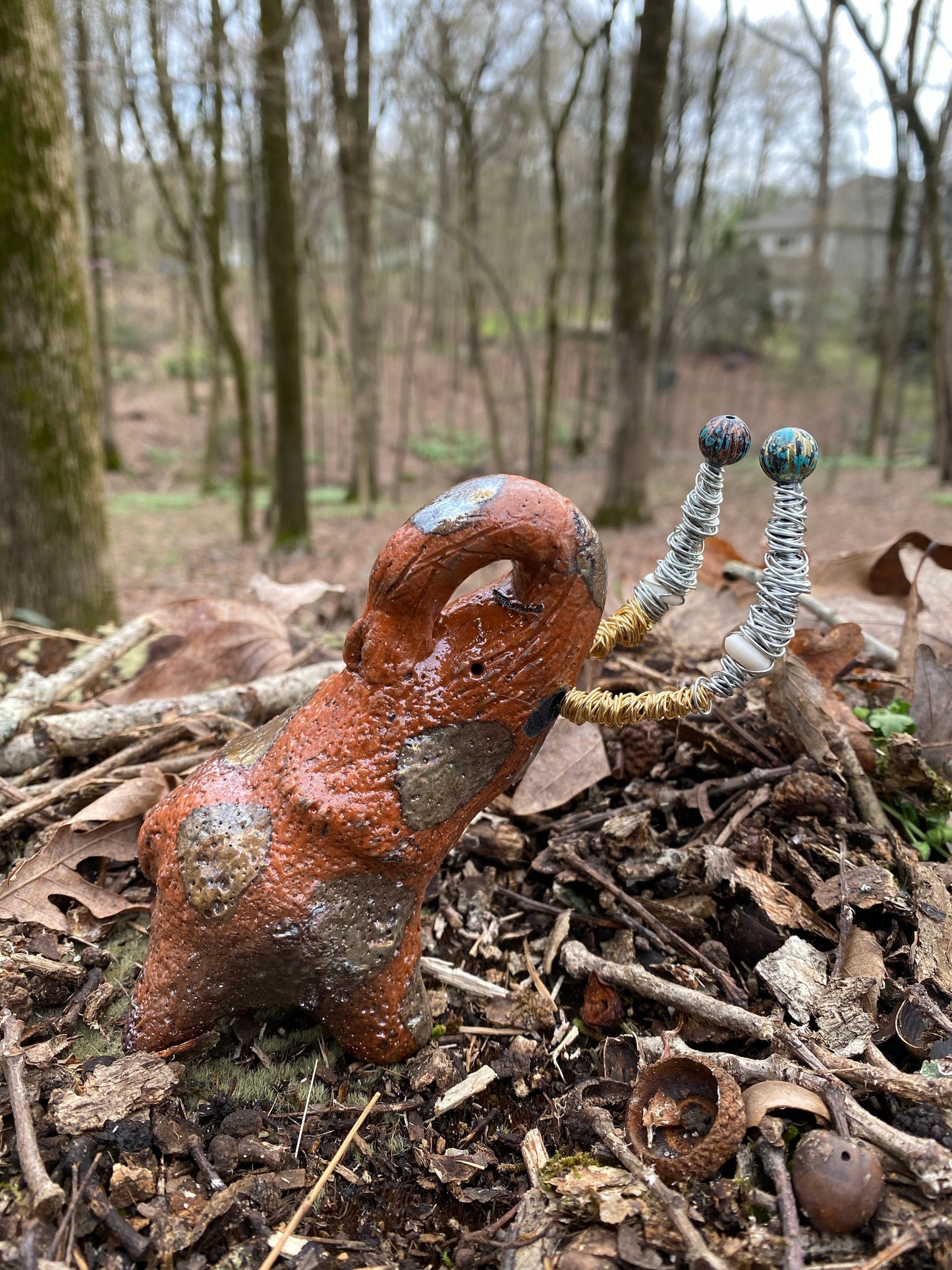 Raku Elephant Have you HERD!!!!!! Just one of these lovely Raku Fired Elephant will make an excellent gift for your friend, sorority or for your home’ special place centerpiece. 7" x 4" x 3" 11 ozs. Beautiful metallic gold and orange raku elephant For decorative purposely only.