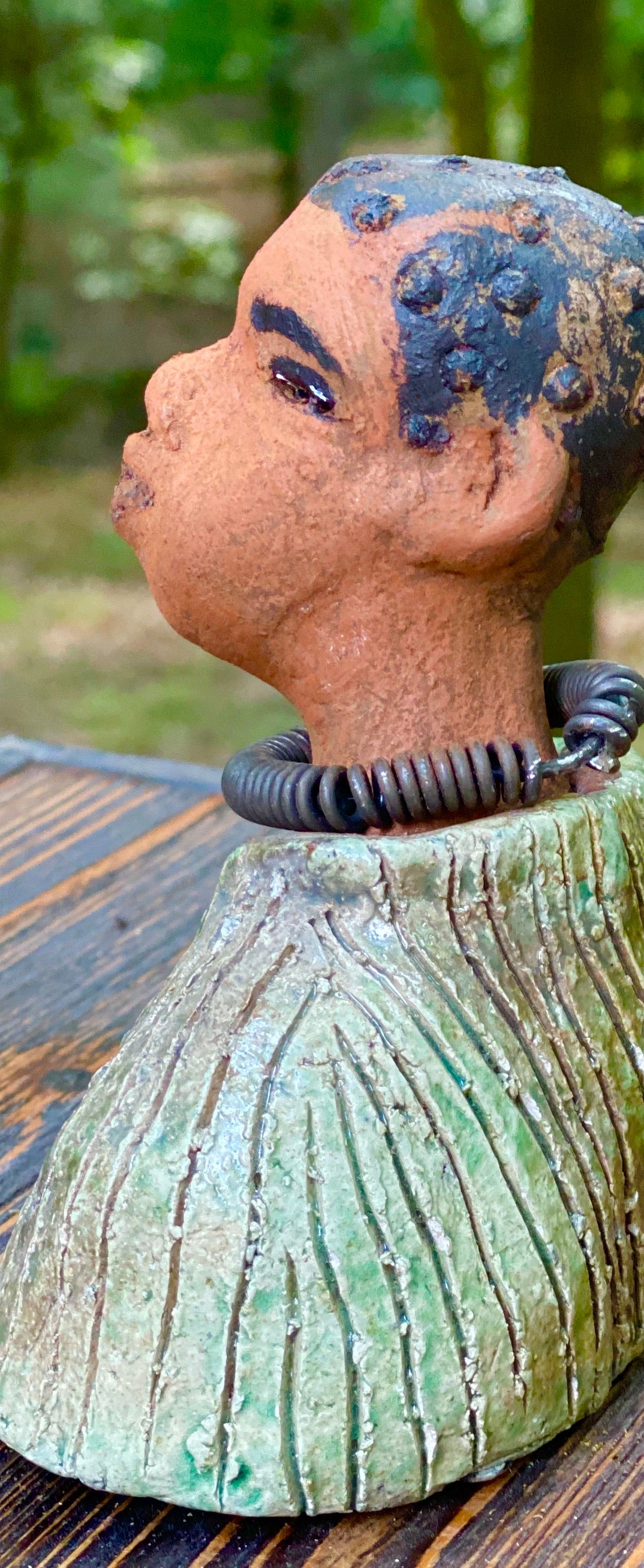 "It is obvious Herdew implies that most of my sculptures are female. My goal this year is to create ten male sculptures. Alvin is one of the first that I am pleased with. Pete stands 5" x 4" x 3" and weighs 10 ozs. He wears an etched metallic multi colored jacket with a cioled wire necklace. Pete has a honey brown complexion. Pete seems to be in deep thought about his next move in life. Pete  would display proudly in your home.