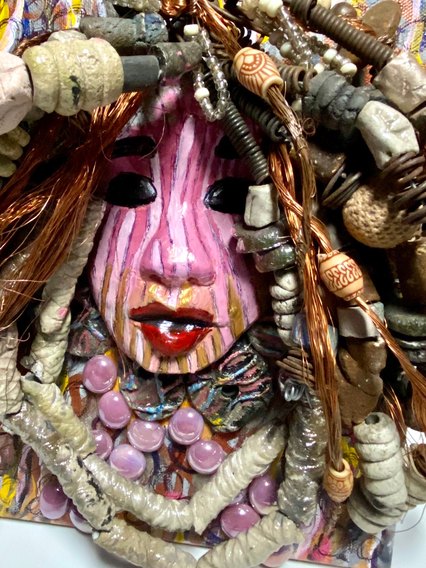 Sabra is mounted on a 8"x 10"painted canvas. I spent about 4 hours or more just fixing April's hair and attaching her beads! She has over 60 feet of 16 gauge wire with multiple strands of copper wire for hair and over 50 raku beads. Sabra has a striped pink crackle face with and ruby red lips. She is ready to be hung!