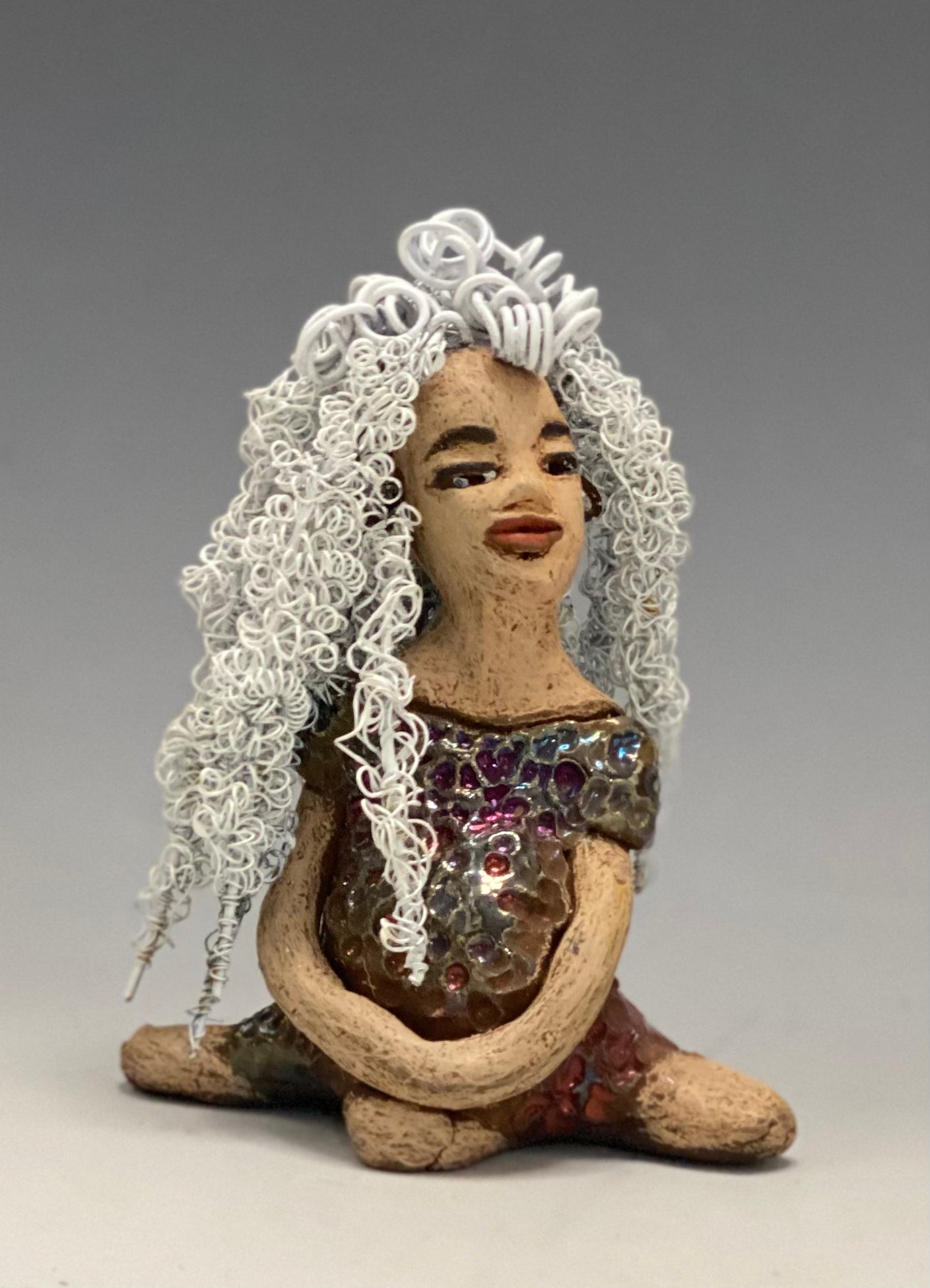 Alyssa stands 6" x 5" x 5" and weighs 12 ozs. She has a lovely honey brown complexion with cocoa brown lips. She has long twisted white wire locs hairstyle waist down! Alyssa has a metallic copper antique glazed dress. She has over 75 feet of 16 and 24 gauge white wire for hair. It took over 3 hours just to do her hair! With eyes wide opened, Brianna has hope of finding a new home. You will love having Alyssa. She will attract and spark conversation with guest in your home!