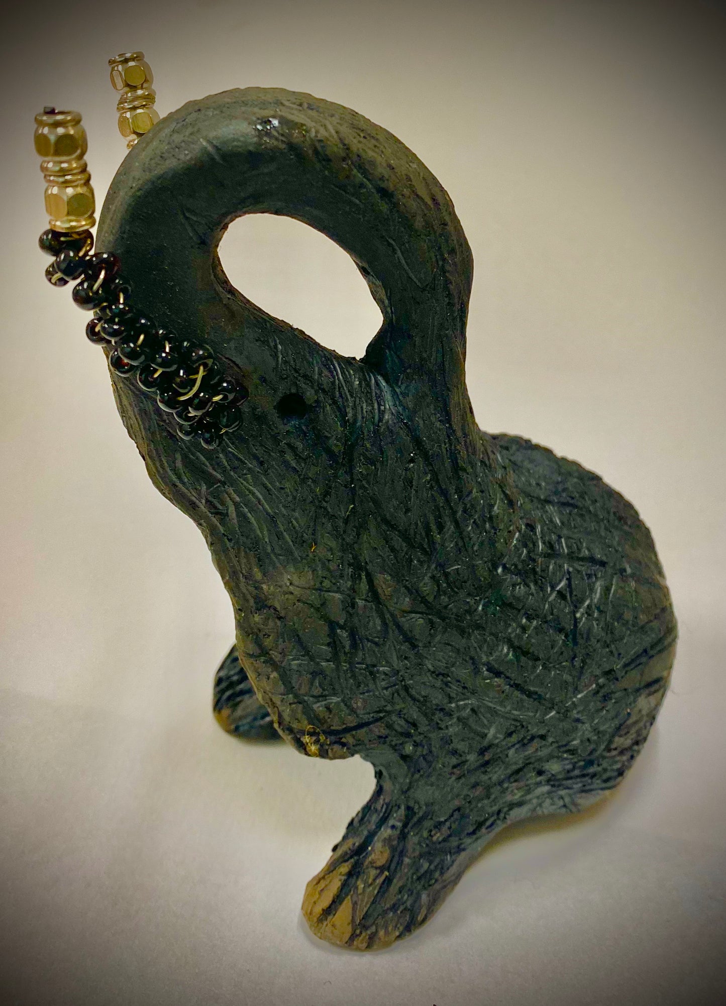 Have you HERD!!!!!! Elephants are one of my favorite animals to create. They are so majestic" Just one of these lovely Raku Fired Elephant will make an excellent gift for your BFF, or just for you . This raku fired elephant stands 7" x 2" x 2.5" and weighs 10 ounces. She has beaded tusks and a textured charcoal body. Nice!