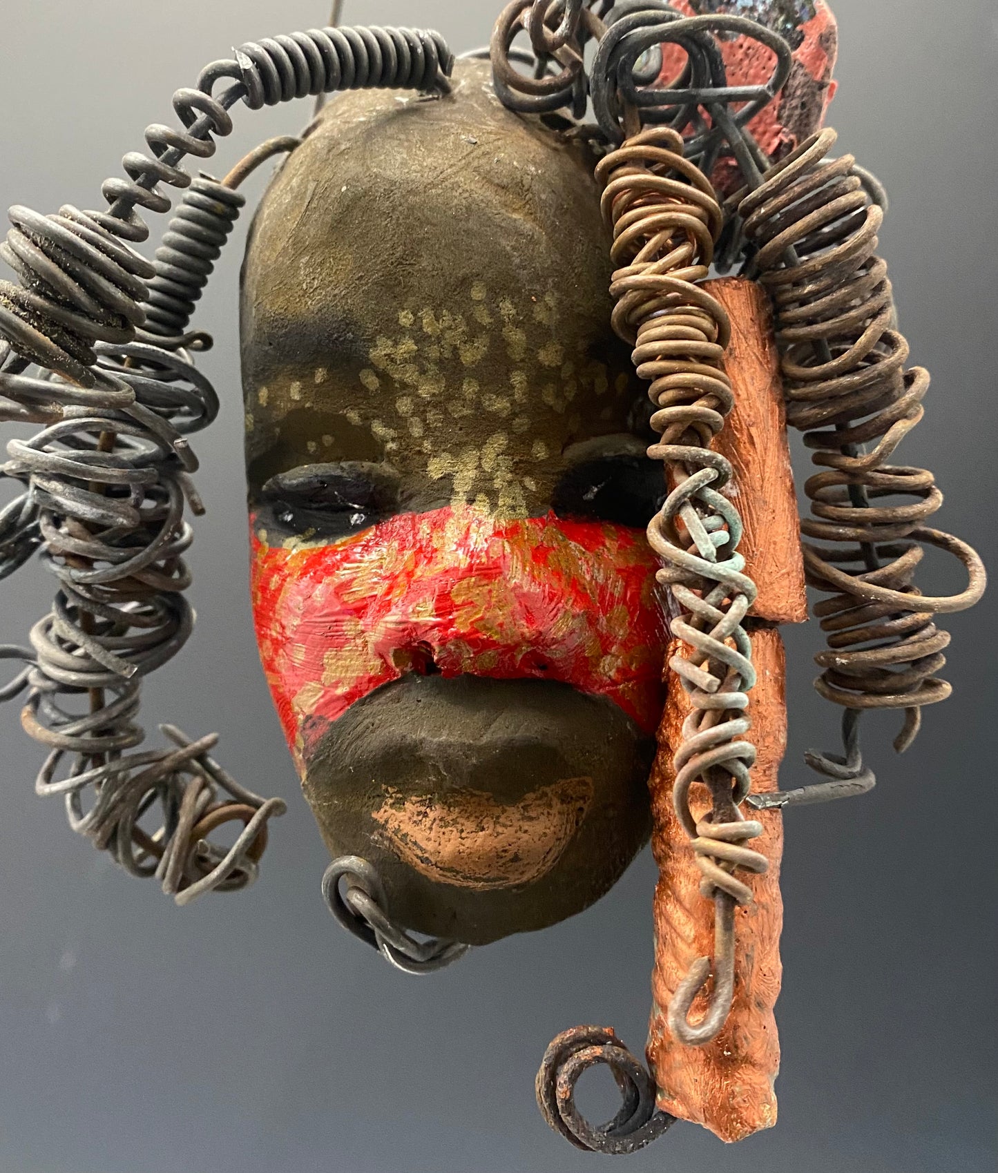 I started making art soon after seeing authentic African artwork at the Smithsonian Museum of African Art. I was in total awe. Gaby was inspired by my visit there. Gaby has a two tone complexion of earthy browns and bright red.. She is 5" x 4" and weighs 7.4 ozs. Gaby has 3 handmade raku fired beads. She has over 5 feet of coiled 16 gauge wire hair. Got Questions????